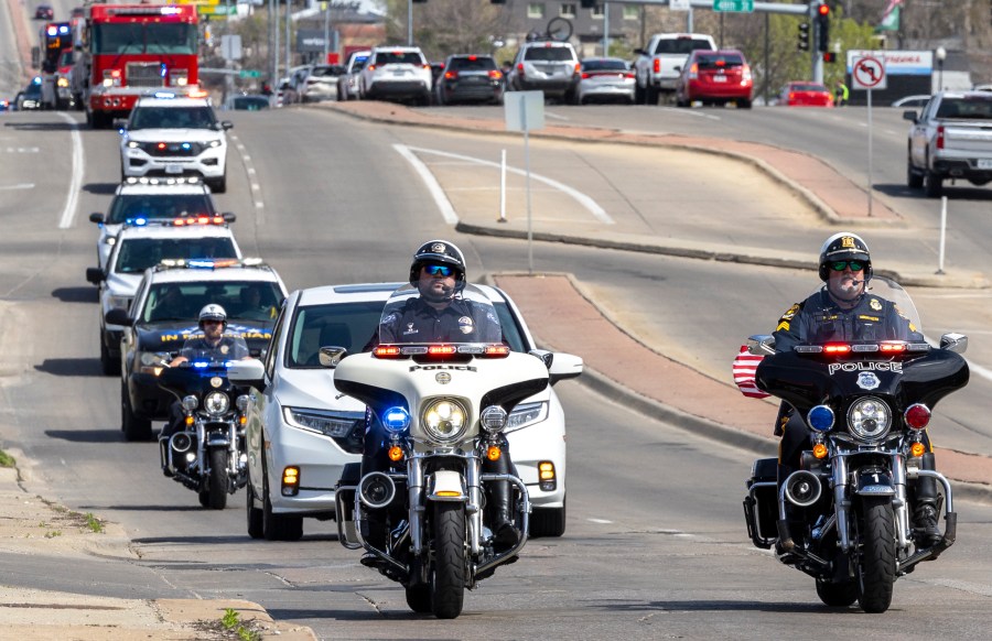 Nebraska law enforcement holds a procession to escort fallen Ceresco Officer Ross Bartlett, Saturday, April 13, 2024, in Lincoln, Neb. The veteran police officer was killed when his cruiser was struck by another vehicle after he made a traffic stop in eastern Nebraska, authorities said Saturday. (Justin Wan/Lincoln Journal Star via AP)