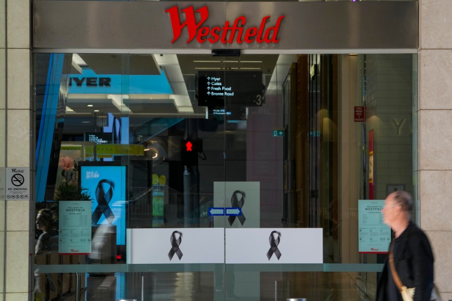 A man walks past the entrance to the Westfield mall at Bondi Junction in Sydney, Thursday, April 18, 2024. The Sydney shopping mall has been opened to the public for the first time since it became the scene of a mass stabbing in which six people died, while the Australian prime minister has flagged giving citizenship to an immigrant security guard who was injured while confronting the knife-wielding attacker. (AP Photo/Mark Baker)