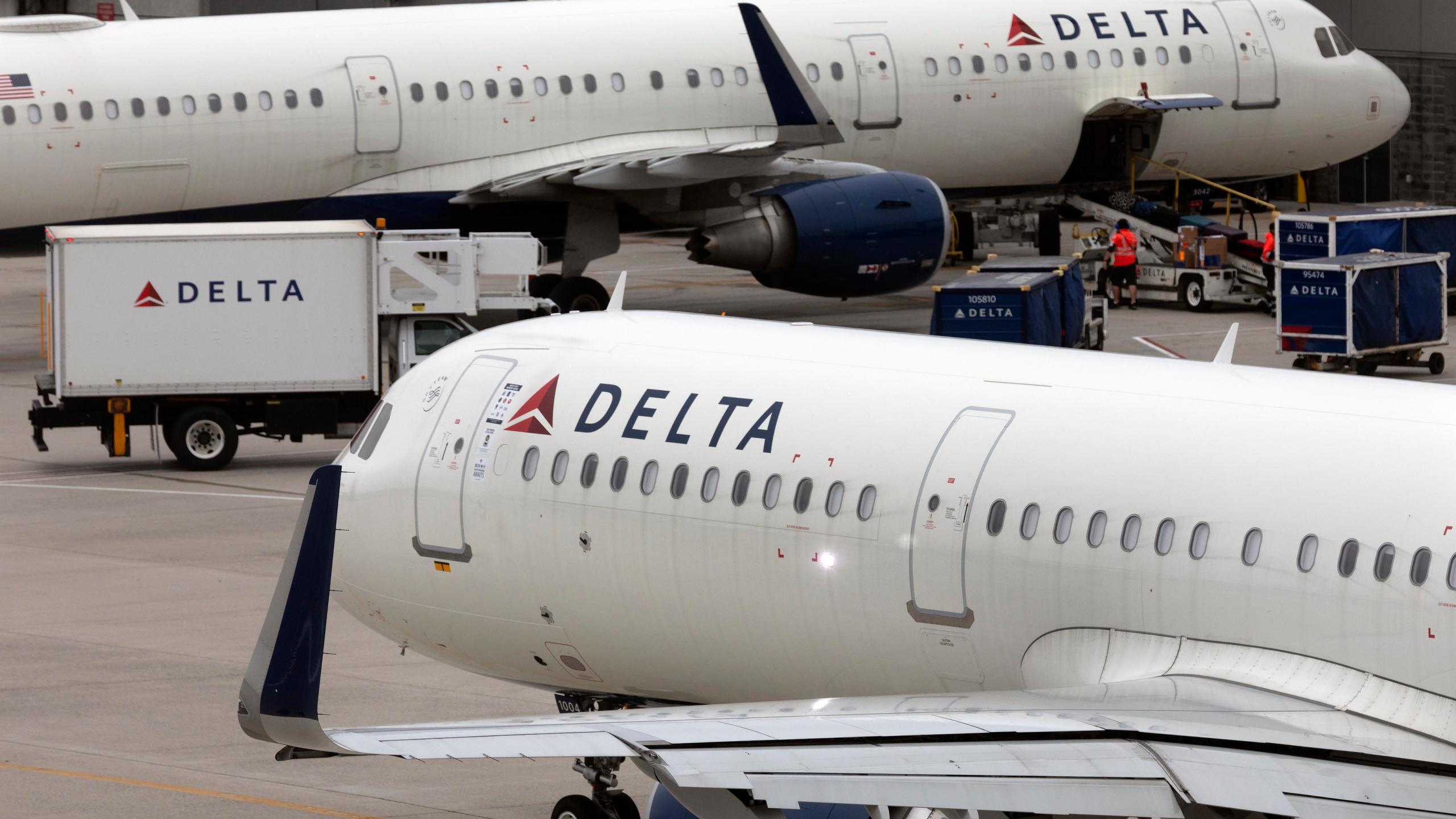 FILE - A Delta Air Lines plane leaves the gate on July 12, 2021, at Logan International Airport in Boston. Delta is raising pay for flight attendants and other nonunion workers by 5%. And the airline is boosting starting pay for all its U.S. jobs to at least $19 an hour. Delta CEO Ed Bastian announced the pay raises in a memo Monday, April 22, 2024 to employees. (AP Photo/Michael Dwyer, File)