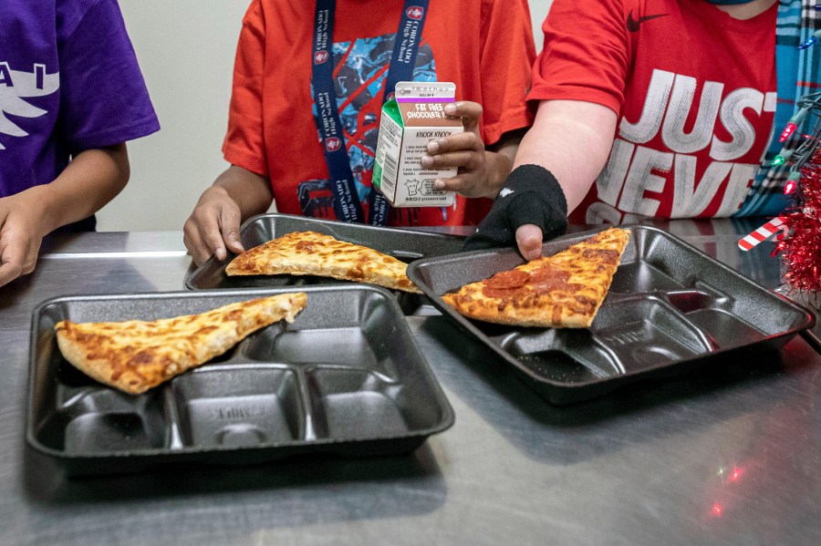 FILE - Second-grade students select their meals during their lunch break in the cafeteria, Dec. 12, 2022, at an elementary school in Scottsdale, Ariz. The nation's school meals will get a makeover under new nutrition standards that limit added sugars for the first time, the U.S. Department of Agriculture announced Wednesday, April 24, 2024. (AP Photo/Alberto Mariani, File)