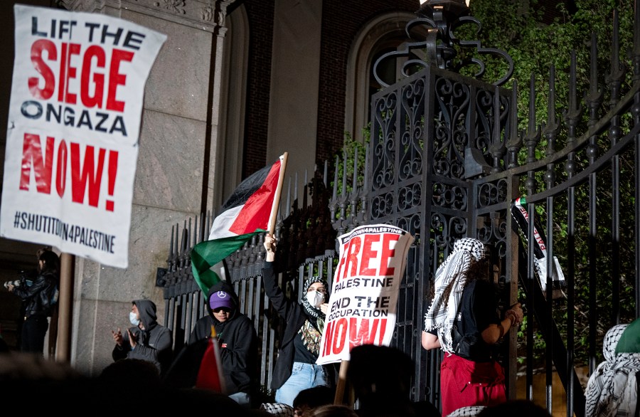 Pro-Palestianian protesters gather near a main gate at Columbia University in New York, Tuesday, April 30, 2024, just before New York City police officers cleared the area after a building was taken over by protesters earlier in the day. The building and a tent encampment were cleared during the operation. (AP Photo/Craig Ruttle)