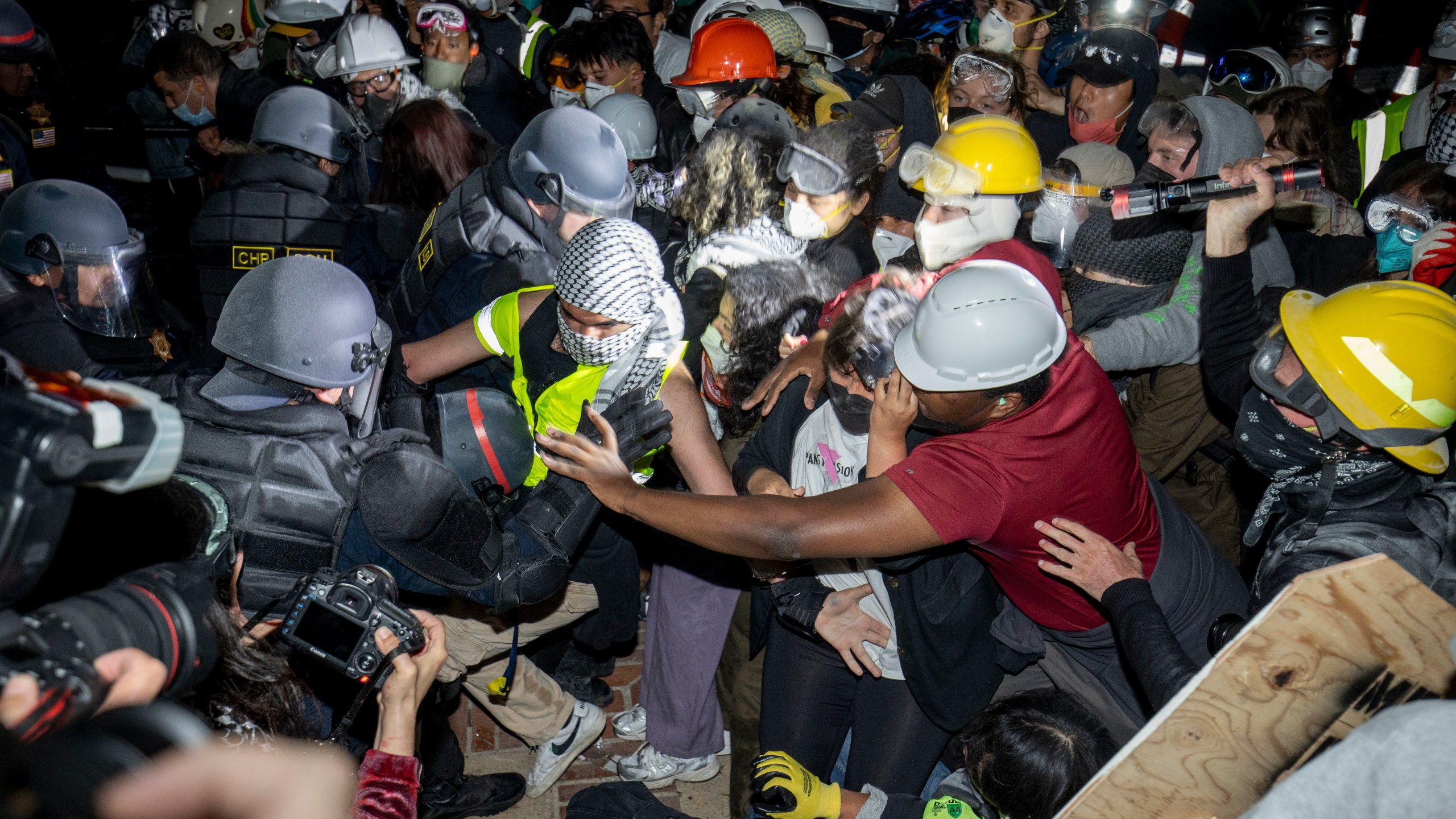 Police advance on pro-Palestinian demonstrators on the UCLA campus Thursday, May 2, 2024, in Los Angeles. (AP Photo/Ethan Swope)