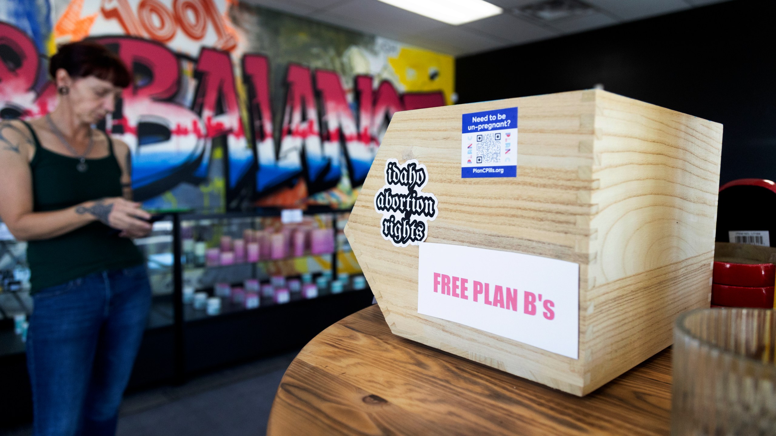 Jen Martindale delivers reproductive health materials to The Honey Pot CBD store in Boise, Idaho, on Saturday, April 13, 2024. The materials are part of kits which include condoms, dental dams, emergency contraceptives, along with sexual and reproductive healthcare pamphlets and are offered for free to businesses in Boise and surrounding areas of Idaho. (AP Photo/Kyle Green)