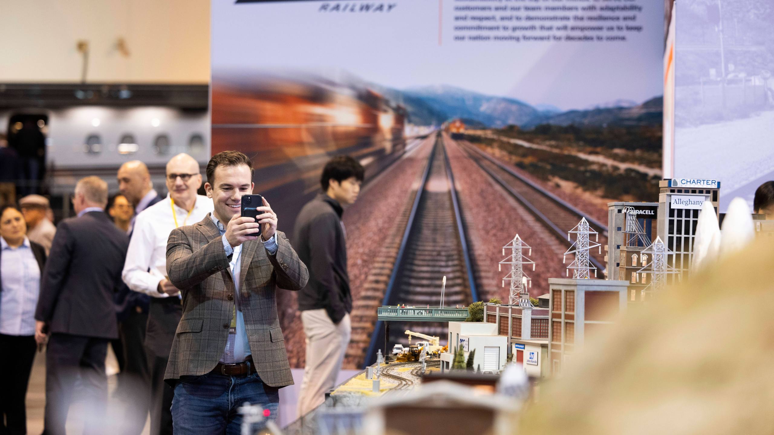 Bart Macdonald of New York City takes photos of the BNSF Railway model train display during the Berkshire Hathaway annual meeting on Saturday, May 4, 2024, in Omaha, Neb. (AP Photo/Rebecca S. Gratz)
