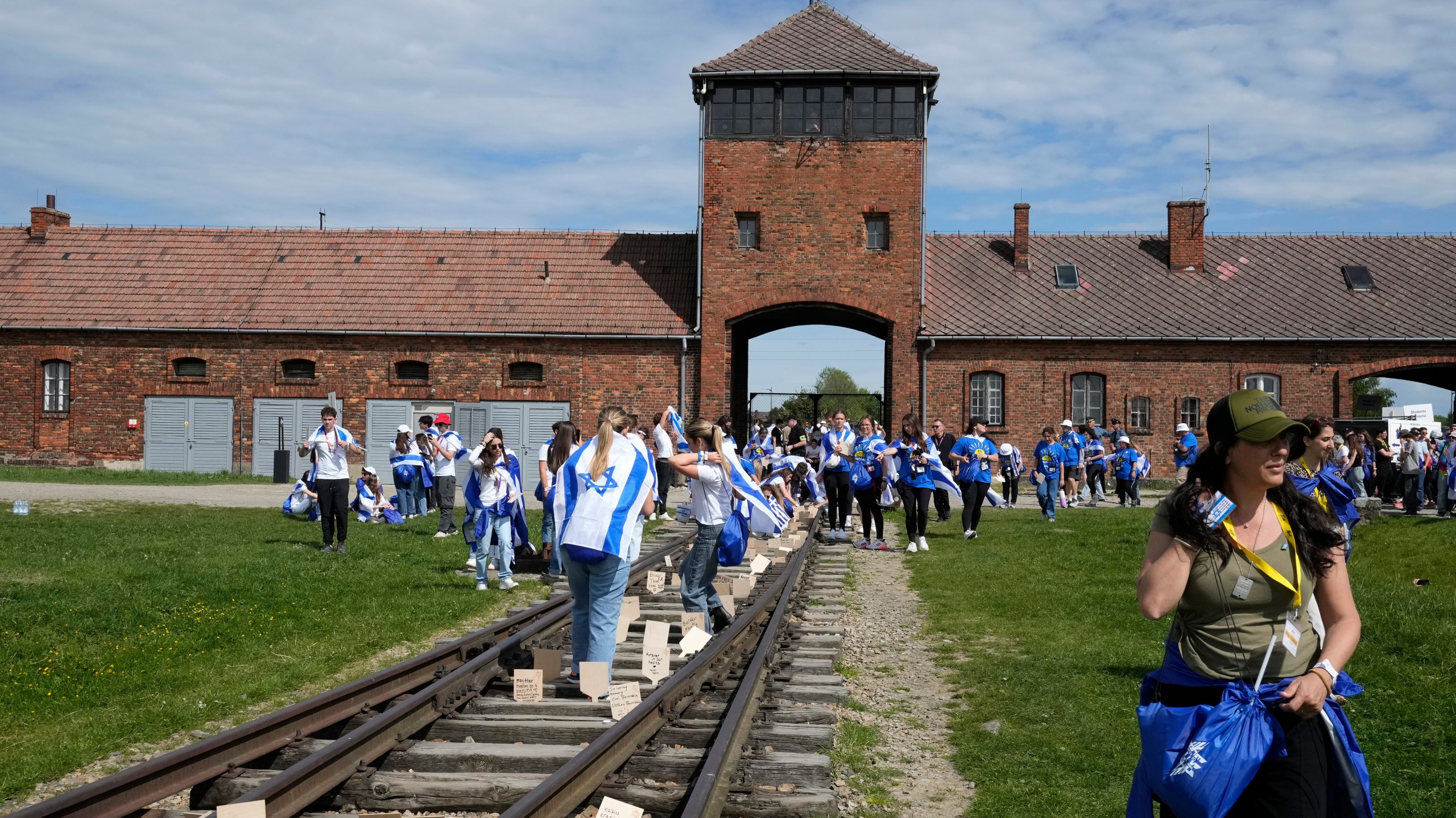 People walk through the former Nazi German death camp of Auschwitz-Birkenau as they attend the annual Holocaust remembrance event, the "March of the Living" in memory of the six million Holocaust victims in Oswiecim, Poland, Monday, May 6, 2024. The event comes amid the dramatic backdrop of the violence of the Israel-Hamas war after the Oct. 7 Hamas attack, the deadliest violence against Jews since the Holocaust, and as pro-Palestinian protests sweep U.S. campuses. (AP Photo/Czarek Sokolowski)