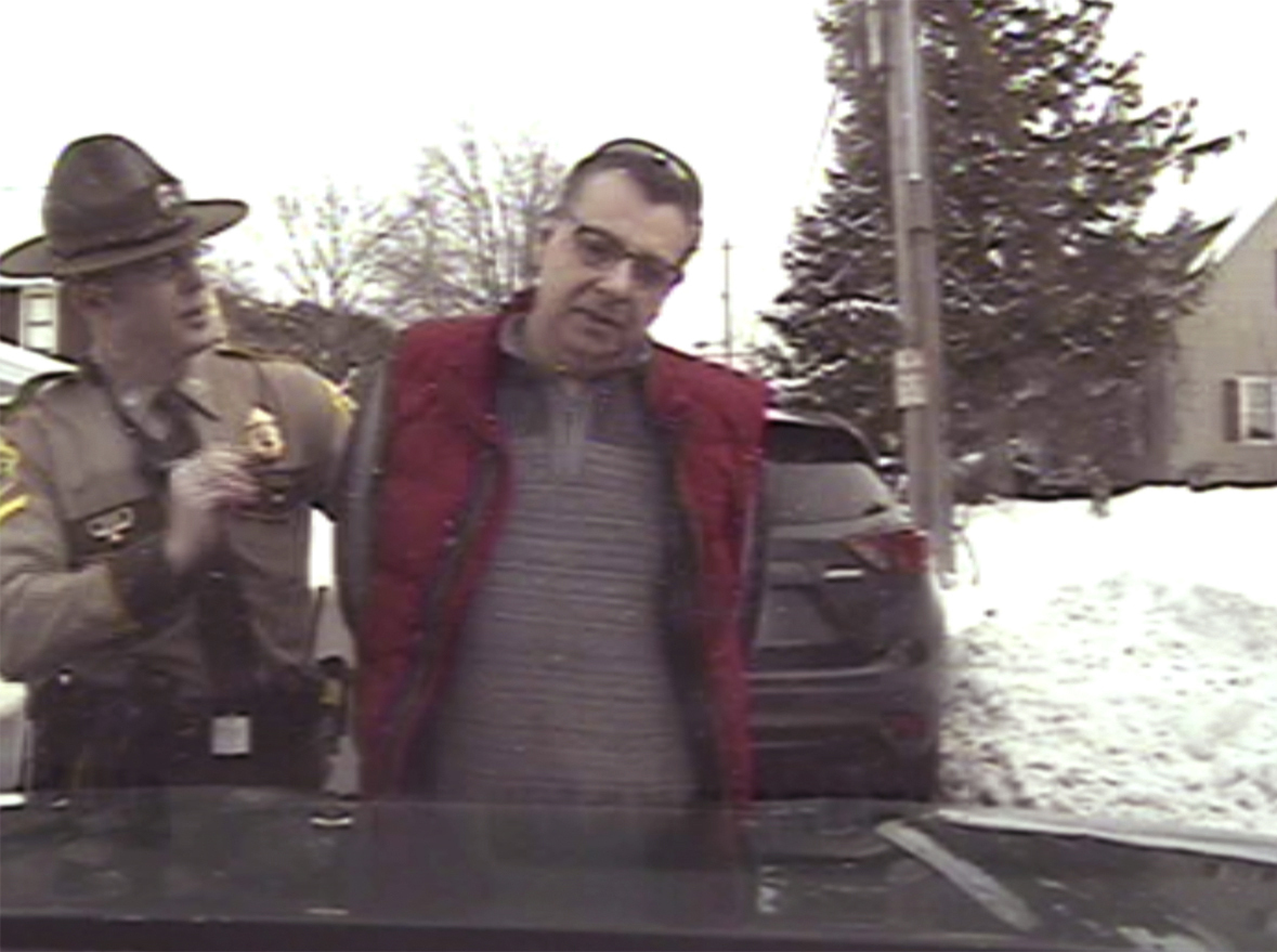 This image taken from police dashcam video shows Gregory Bombard getting arrested on Feb. 9, 2018 n St. Albans, Vt. Vermont has agreed to pay $175,000 to settle a lawsuit on behalf of Bombard who was charged with a crime for giving a state trooper the middle finger in 2018, the state chapter of the American Civil Liberties Union said Wednesday, June 26, 2024. (American Civil Liberties Union/Vt. State Police via AP)