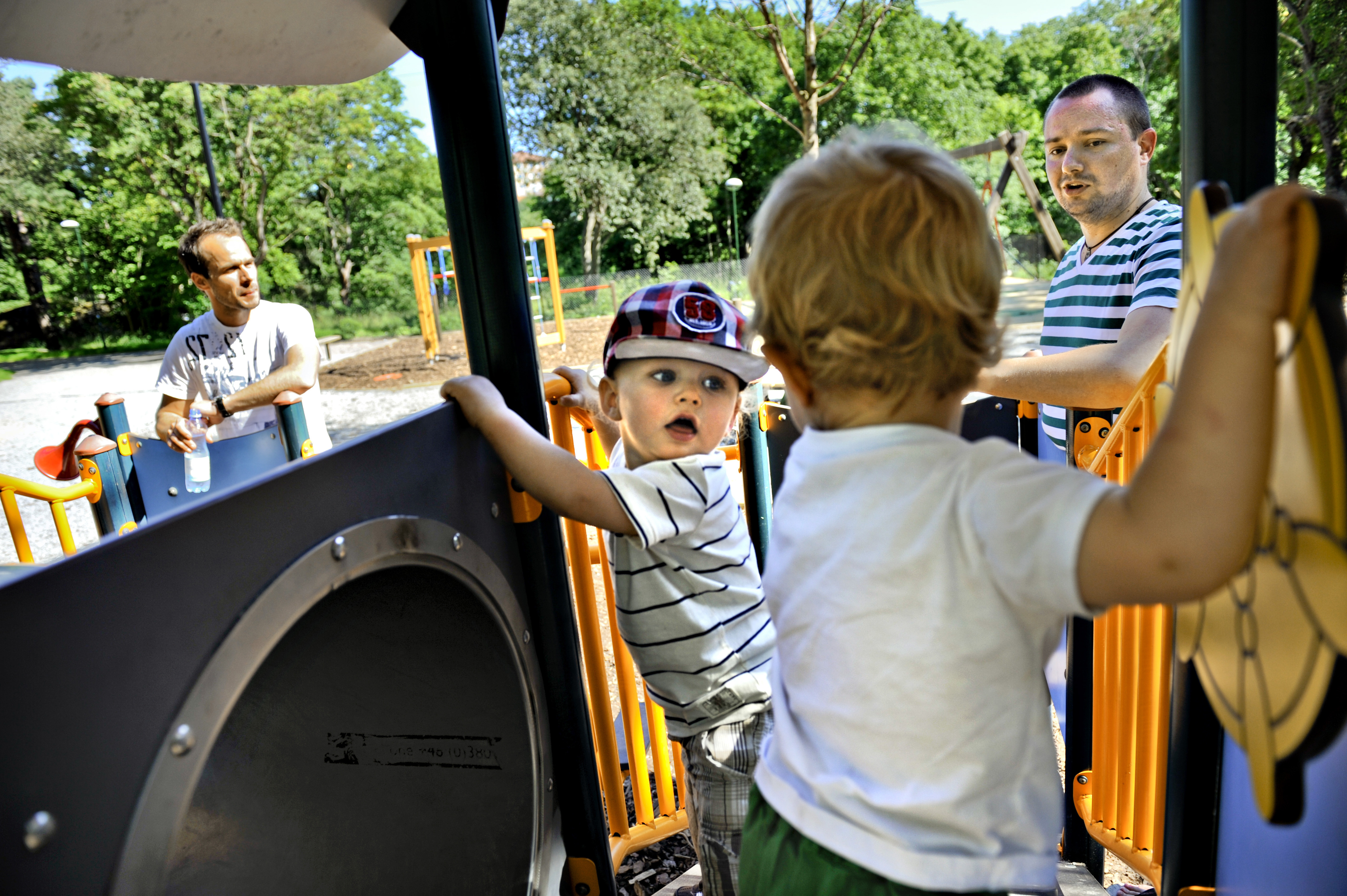 FILE - Henrik Holgersson, right, watches his son, Arvid, center with hat, play with Walter Johansson accompanied by his father Henrik Johansson at a playground in Stockholm, Sweden, Wednesday June 29, 2011. Fifty years after Sweden became the first country in the world to introduce paid parental leave for fathers, the Scandinavian country has launched a groundbreaking new law granting paid leave allowing grandparents and other legal guardians to care for a child. The law came into effect Monday, July 1, 2024. (AP Photo/Niklas Larsson, File)