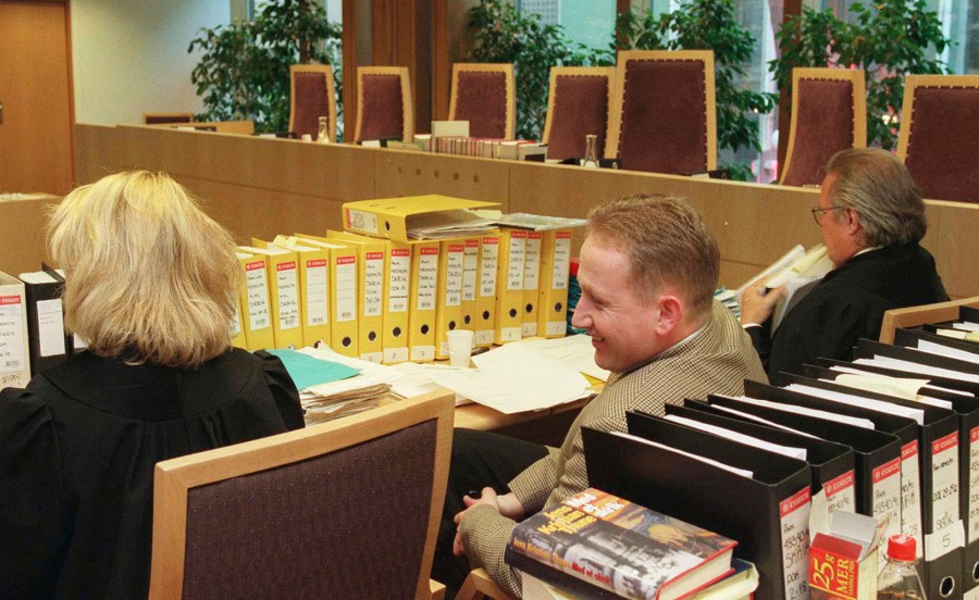 FILE - Pål Enger, center, sits in court during his appeal case, in the Borgarting Court of Appeal in Oslo, Monday, April 7, 1997. Enger, a talented Norwegian soccer player turned gentleman art thief who pulled off the sensational 1994 heist of Edvard Munch’s famed “The Scream” painting at the National Gallery in Oslo and later exhibited his abstract paintings in a gallery, is dead at 57. Press officer Tina Wulf at Vålerenga Fotball, an acclaimed Oslo soccer club, told the Associated Press on Tuesday, July 2, 2024, that Enger died Saturday evening. (Bjørn Sigurdsøn/NTB Scanpix via AP, File)