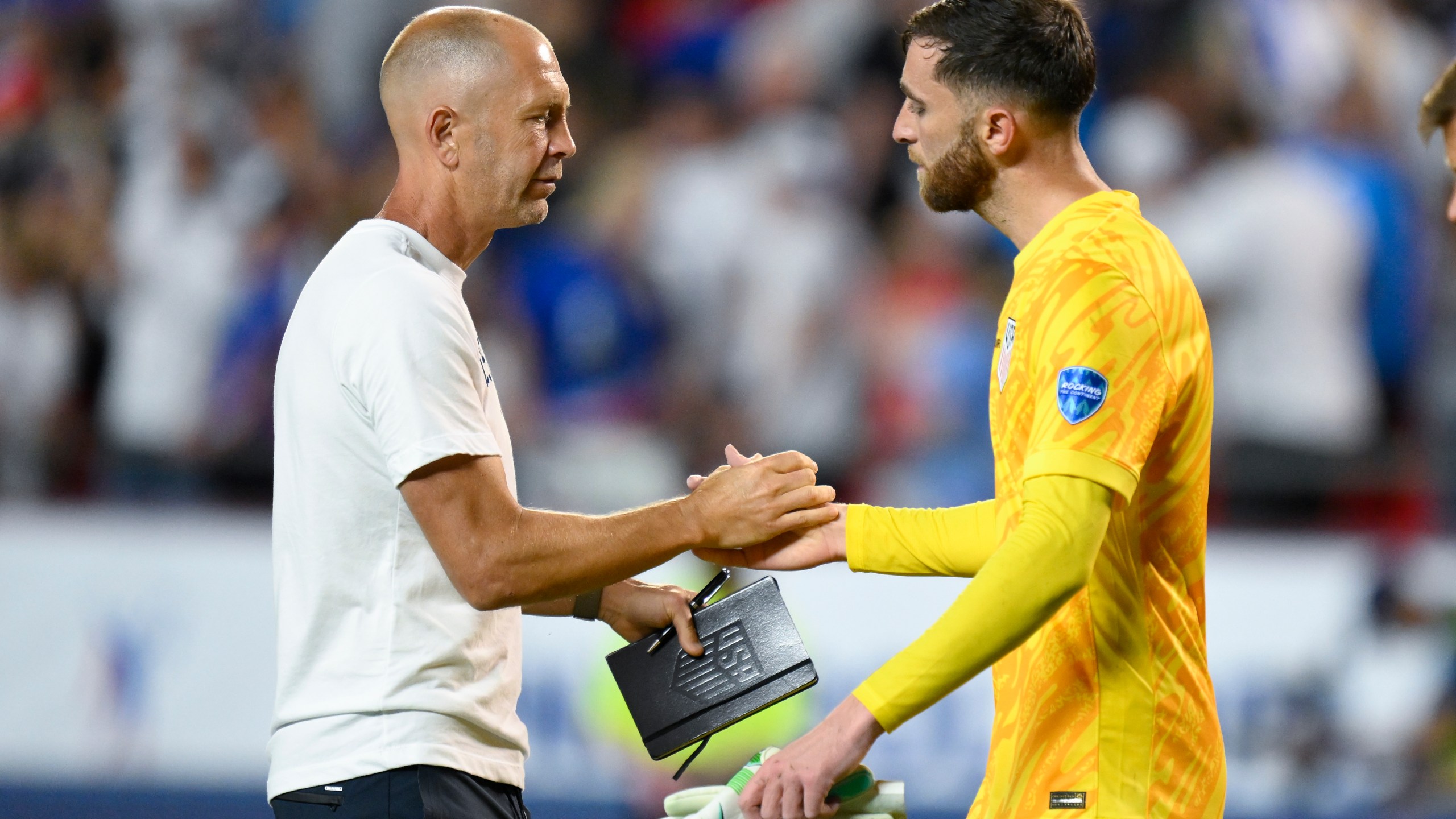 Coach Gregg Berhalter of the United States greets goalkeeper Matt Turner after losing 0-1 against Uruguay at the end of a Copa America Group C soccer match in Kansas City, Mo., Monday, July 1, 2024. (AP Photo/Reed Hoffman)