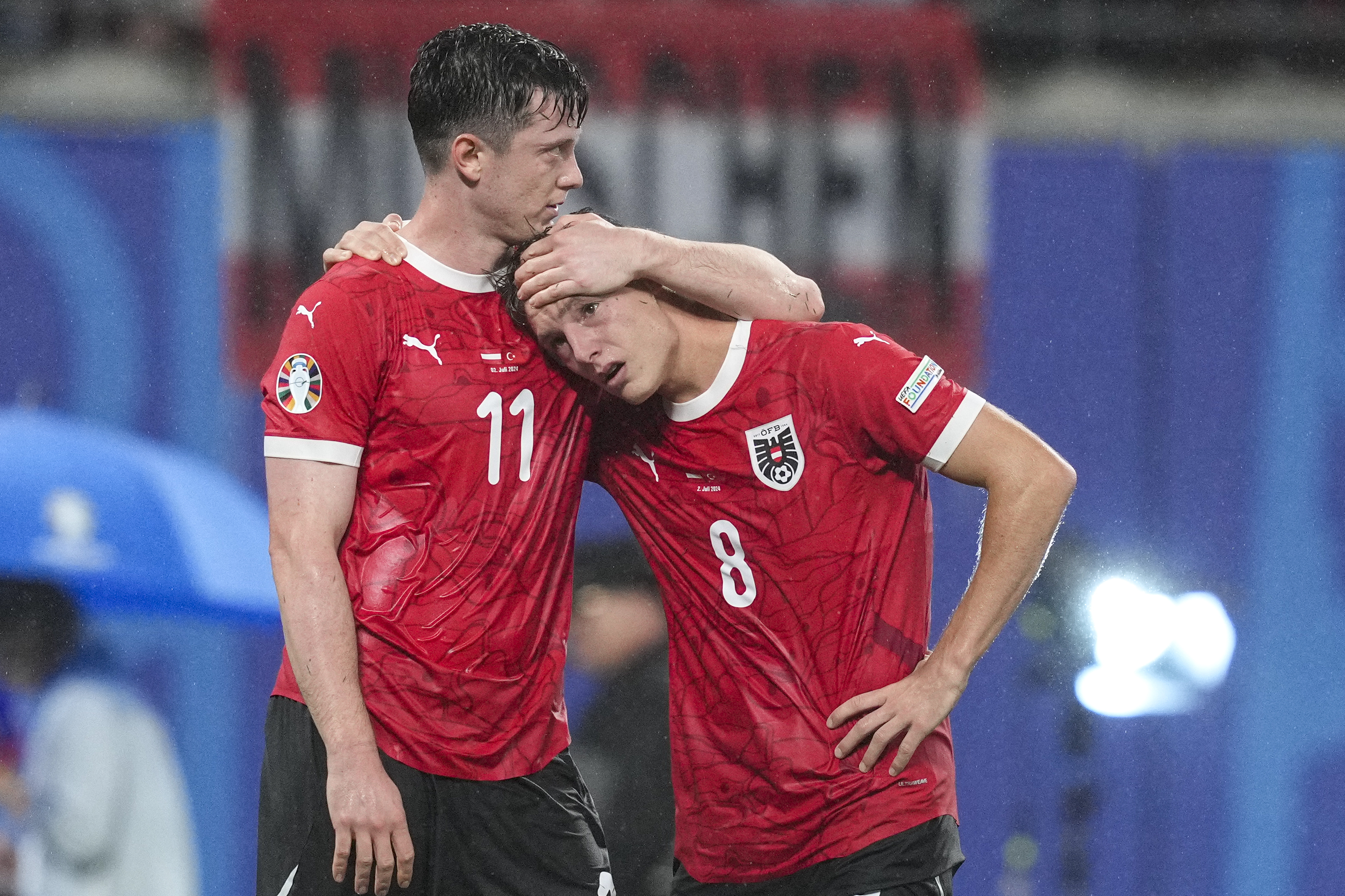 Austria's Michael Gregoritsch comforts Austria's Alexander Prass after a round of sixteen match between Austria and Turkey at the Euro 2024 soccer tournament in Leipzig, Germany, Tuesday, July 2, 2024. (AP Photo/Andreea Alexandru)
