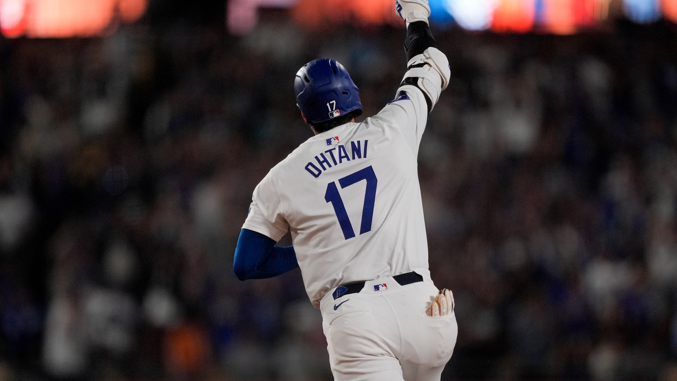 Los Angeles Dodgers designated hitter Shohei Ohtani celebrates while running the bases after hitting the go-ahead two-run home run during the seventh inning of a baseball game against the Arizona Diamondbacks, Tuesday, July 2, 2024, in Los Angeles. (AP Photo/Ryan Sun)