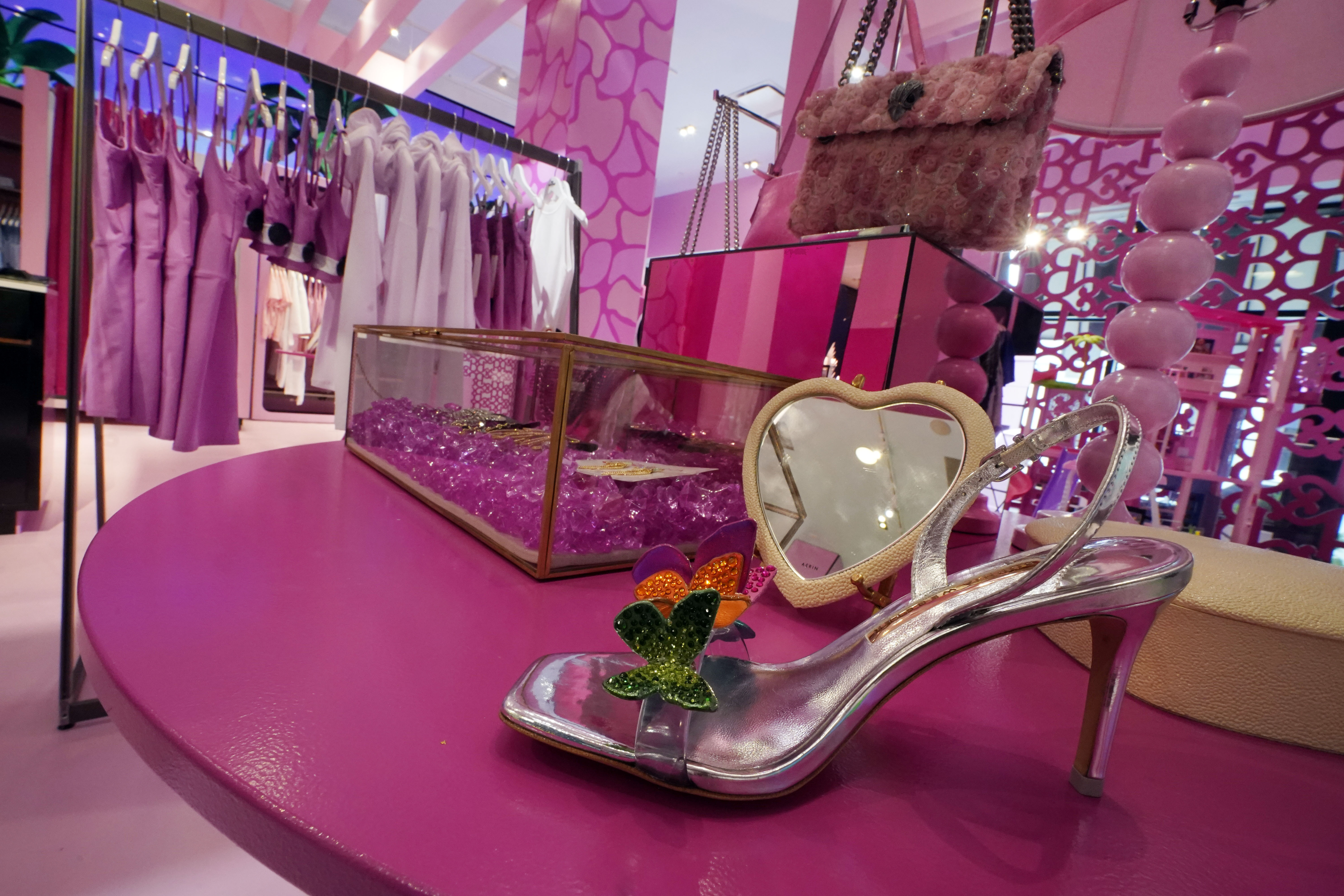 FILE - Barbie-themed merchandise is displayed in a special section at Bloomingdale's, in New York, Thursday, July 20, 2023. According to the fashion company LYST, the "Barbiecore" trend began after pictures of a pink-clad Margot Robbie surfaced online in June 2022, a year before the actor's "Barbie" movie came out and toy maker Mattel launched its own marketing blitz to promote the color. (AP Photo/Richard Drew, File)
