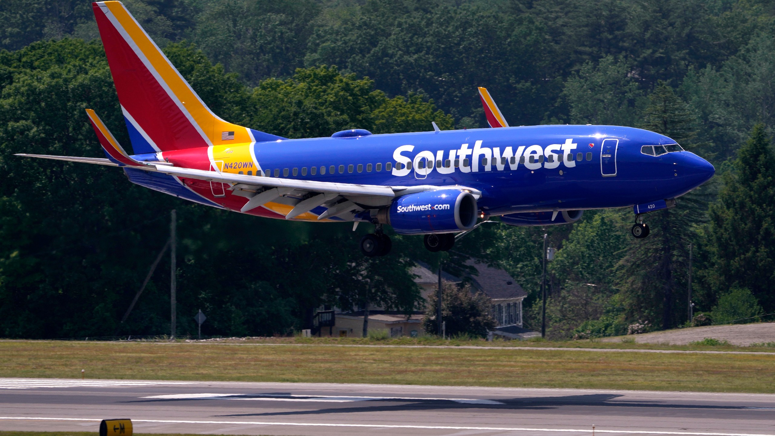 FILE - Southwest Airlines Boeing 737 lands at Manchester Boston Regional Airport, June 2, 2023, in Manchester, N.H. Southwest Airlines has adopted a ‘poison pill’ following activist investor Elliott Investment Management taking a significant stake in the company. The airline said Wednesday, July 3, 2024, that the shareholder rights plan is effective immediately and expires in a year. For any extension to occur, Southwest shareholders would need to give prior approval.(AP Photo/Charles Krupa, File)