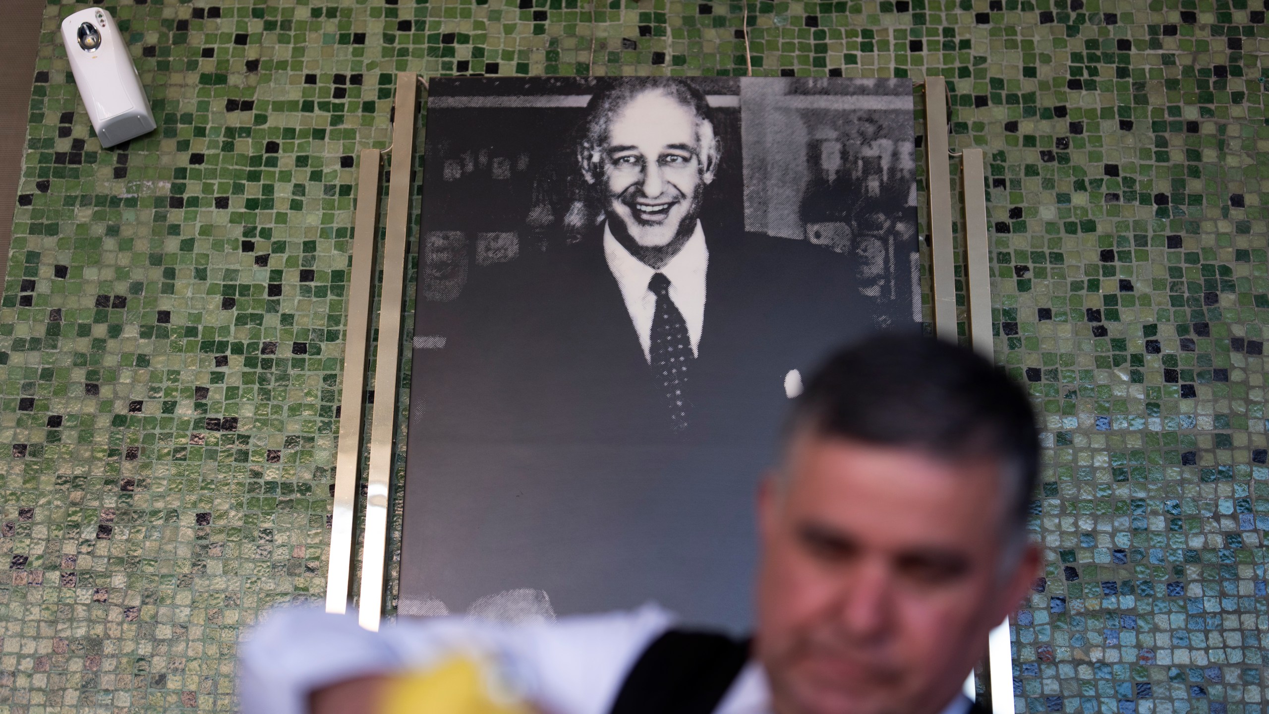 Salad Master Efrain Montoya prepares a Caesar salad in front of an image of the inventor of the salad, Caesar Cardini, at Ceasar's restaurant Thursday, June 27, 2024, in Tijuana, Mexico. Caesar salad has something to celebrate: It's turning 100. Italian immigrant Caesar Cardini is said to have invented the dish on July 4, 1924, at his restaurant, Caesar's Place, in Tijuana, Mexico. (AP Photo/Gregory Bull)