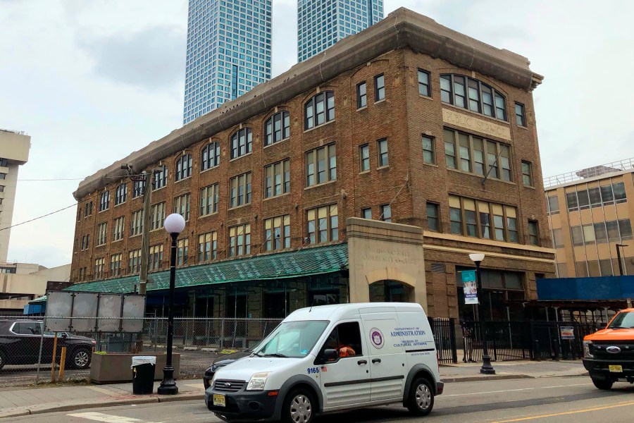 FILE - Vehicles pass the Pathside Building, in Jersey City, NJ, on June 4, 2021. New Jersey officials say financial concerns spurred state lawmakers to rescind $24 million in funding for a planned outpost of Paris’ acclaimed Pompidou Center in Jersey City, but the city's mayor believes his deteriorating relationship with Gov. Phil Murphy led to the decision. (AP Photo/P. Solomon Banda, FILE)