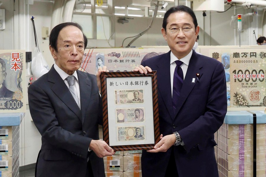 Japanese Prime Minister Fumio Kishida, right, and Bank of Japan Governor Kazuo Ueda hold the country’s new banknotes in a frame, during a ceremony to mark the release of the banknotes, at the BOJ headquarters in Tokyo, Japan, Wednesday, July 3, 2024. (Japan Pool/Kyodo News via AP)