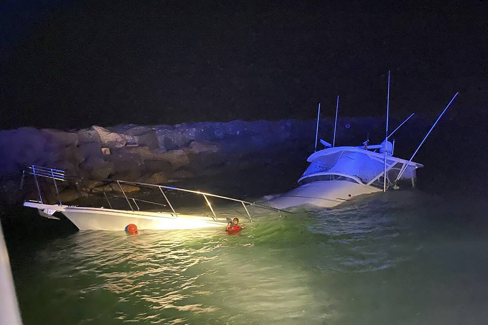 This photo provided by the Long Beach, Calif., Fire Department shows a power boat that crashed into a jetty in Southern California on Wednesday, July 3, 2024, killing one man and injuring 10 other people, officials said. (Long Beach Fire Department via AP)
