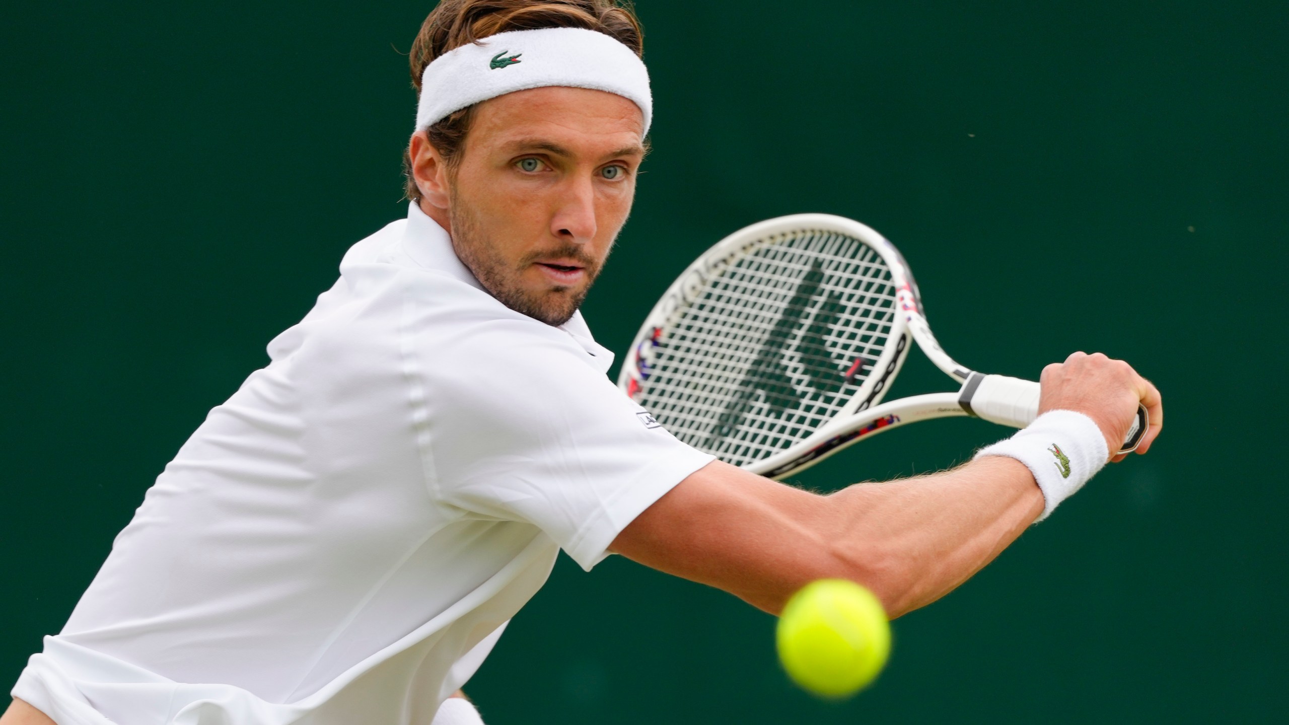 Arthur Rinderknech of France plays a backhand return to Kei Nishikori of Japan during their match on day three at the Wimbledon tennis championships in London, Wednesday, July 3, 2024. (AP Photo/Kirsty Wigglesworth)