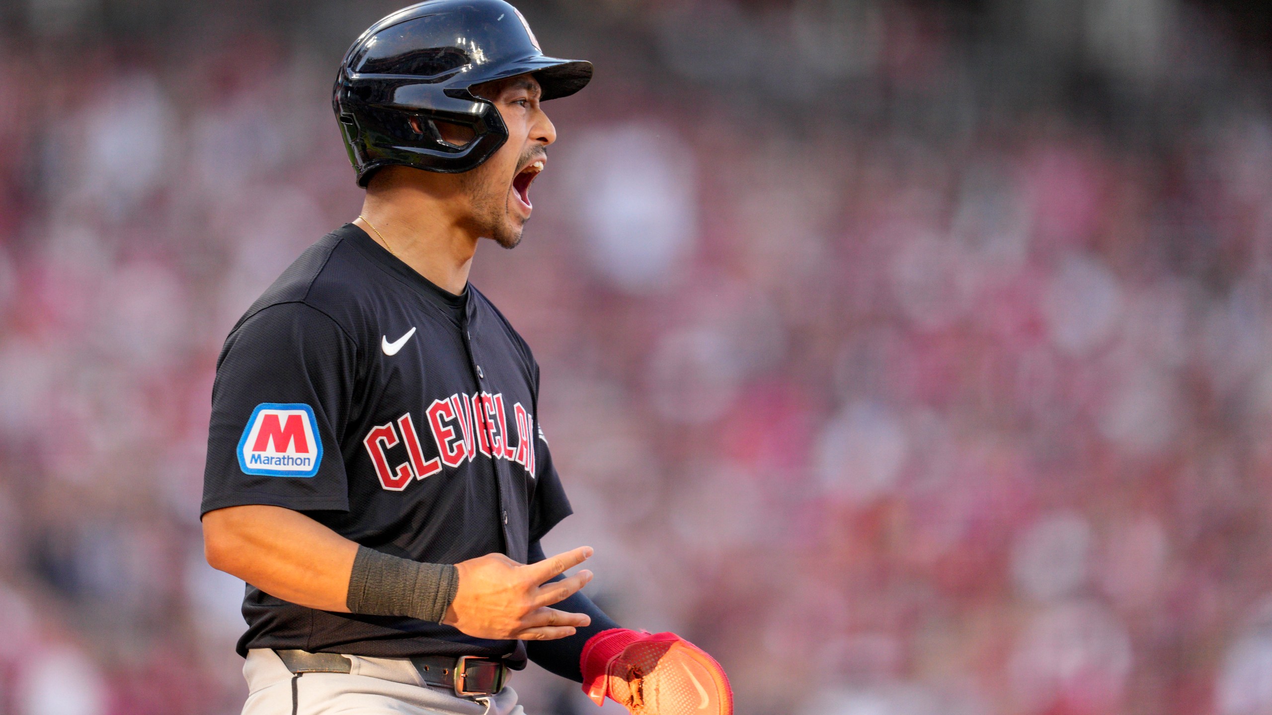 Cleveland Guardians' Steven Kwan scores on a bases-loaded walk issued by the Cincinnati Reds during the third inning of a baseball game in Cincinnati, Wednesday, June 12, 2024. (AP Photo/Jeff Dean)