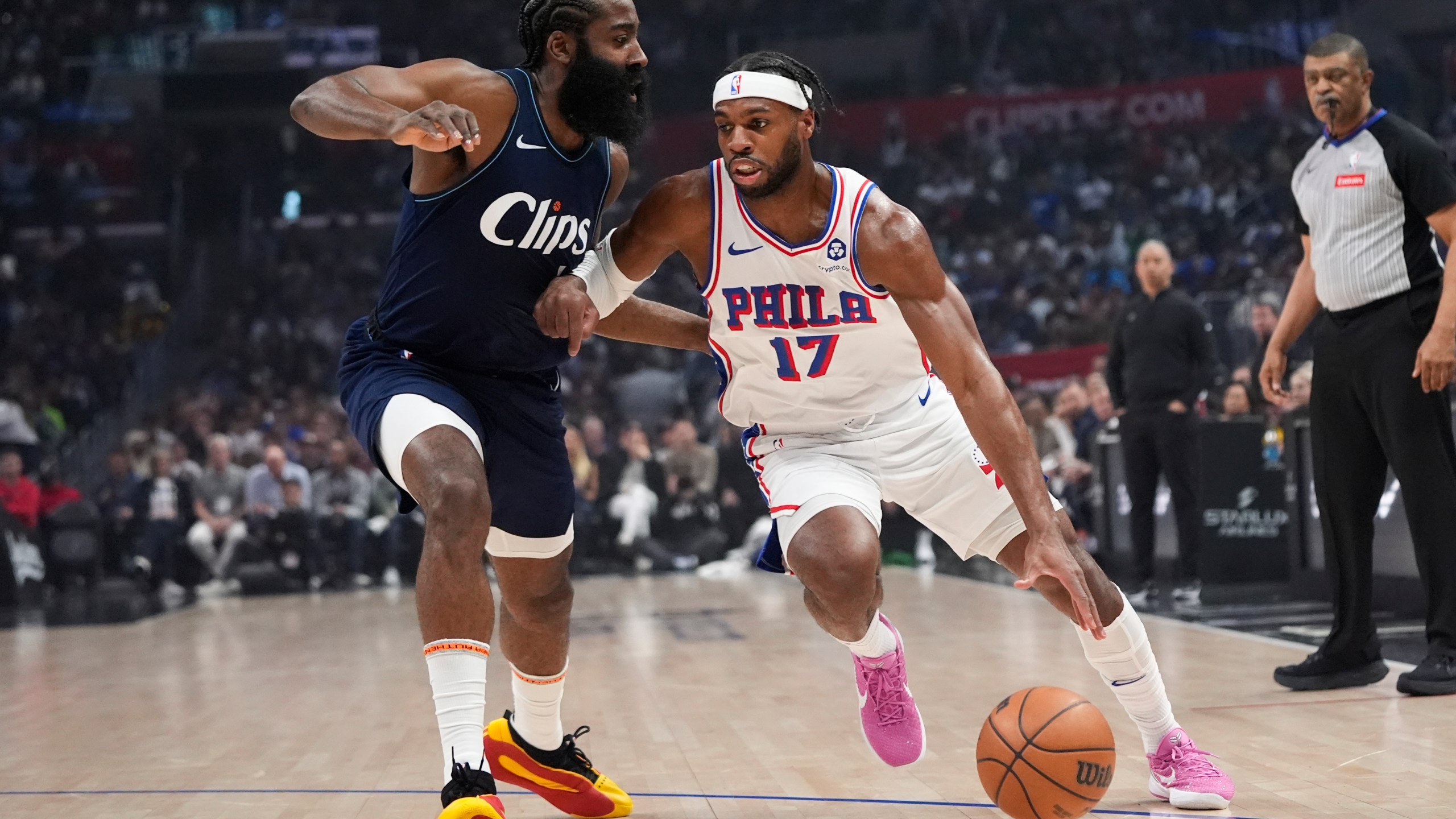 FILE - Philadelphia 76ers guard Buddy Hield (17) drives past Los Angeles Clippers guard James Harden during the first half of an NBA basketball game March 24, 2024, in Los Angeles. The 76ers continued a busy offseason by orchestrating a sign-and-trade deal that sends Hield to the Golden State Warriors for a 2031 second-round draft pick it received from the Dallas Mavericks, according to a person with knowledge of the deal. (AP Photo/Jae C. Hong, File)