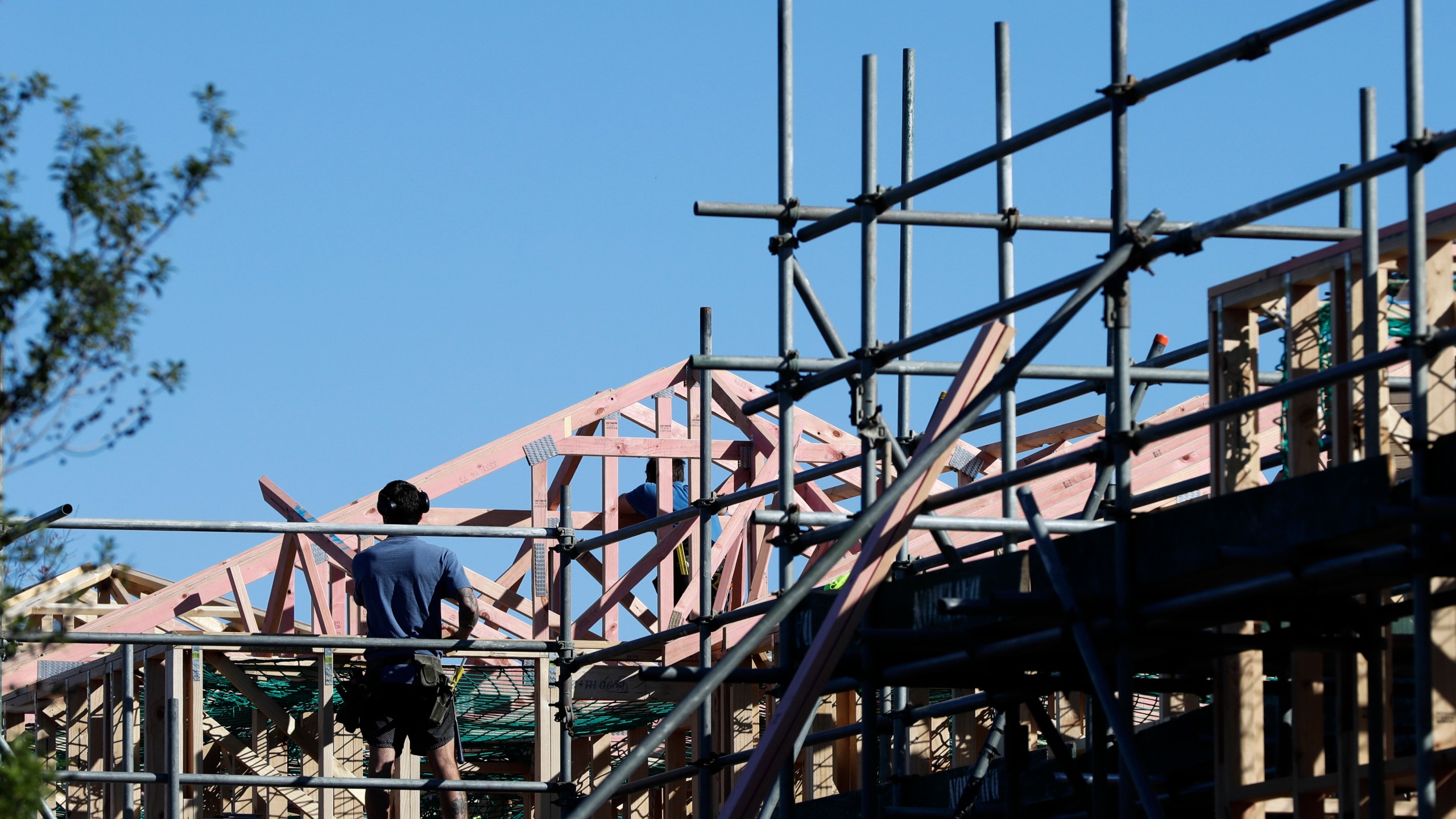 FILE - Builders work on a construction site in Christchurch, New Zealand, April 28, 2020. New Zealand's government introduced sweeping measures to free up land for new homes on Thursday, July 4, 2024, pledging to "flood the market" with opportunities to build houses, and scrap rules for minimum floor areas and balconies in apartments. (AP Photo/Mark Baker, File)