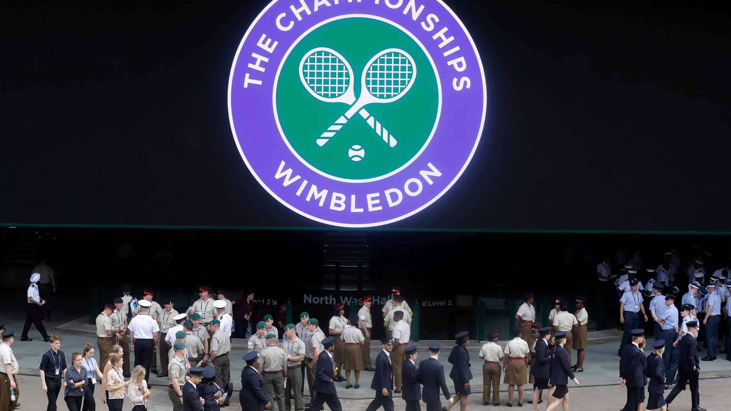 FILE - Stewards prepare for the start of the Wimbledon Tennis Championships in London, Sunday, June 30, 2019. This year's Wimbledon tournament begins on Monday, July 1.(AP Photo/Kirsty Wigglesworth, File)