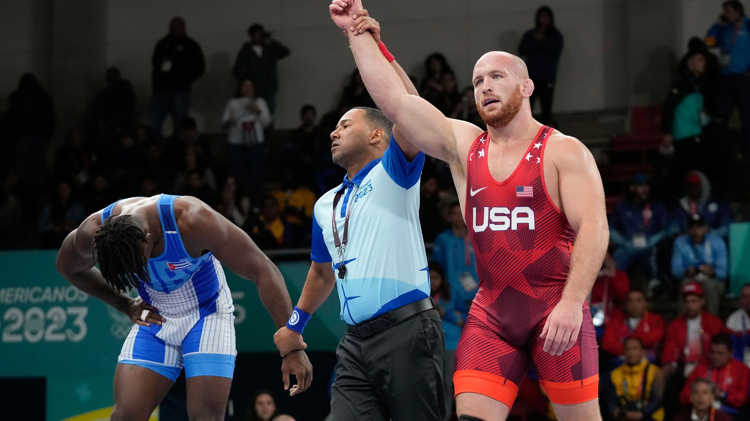 FILE - United States' Kyle Snyder, right, celebrates after winning gold against Cuba's Arturo Silot, left, during the men's 97kg wrestling freestyle final bout at the Pan American Games Santiago, Chile, Wednesday, Nov. 1, 2023. Kyle Snyder already has one of the best resumes ever for a U.S. wrestler, and he’s just now hitting his prime.(AP Photo/Matias Delacroix, File)