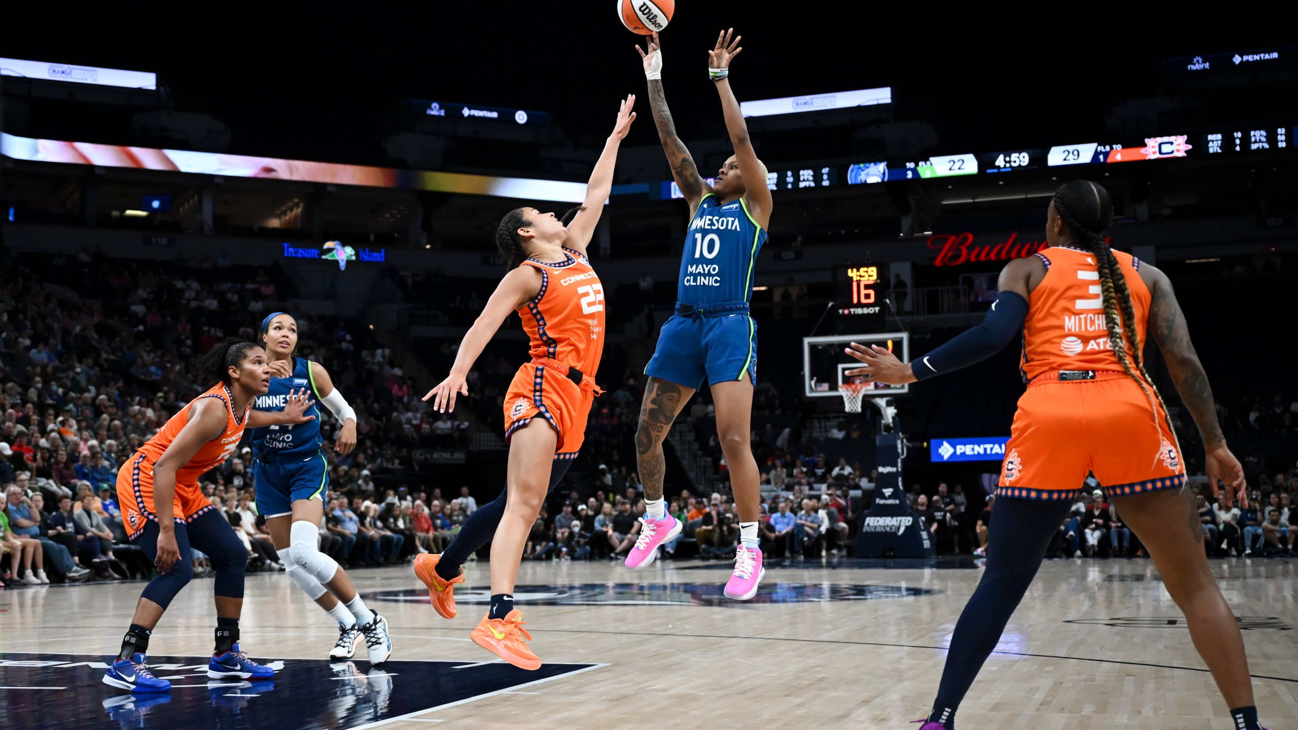 Minnesota Lynx guard Courtney Williams (10) shoots to score on a jump shot in the second quarter as she is defended by Connecticut Sun guard Veronica Burton (22) during a WNBA basketball game Thursday, July 4, 2024, in Minneapolis. (Aaron Lavinsky/Star Tribune via AP)