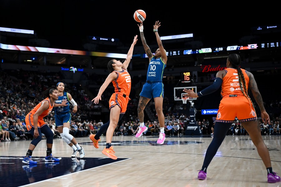 Minnesota Lynx guard Courtney Williams (10) shoots to score on a jump shot in the second quarter as she is defended by Connecticut Sun guard Veronica Burton (22) during a WNBA basketball game Thursday, July 4, 2024, in Minneapolis. (Aaron Lavinsky/Star Tribune via AP)