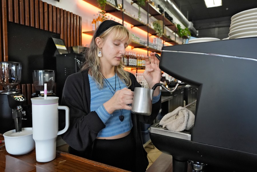 FILE - Samantha Grimison makes a cup of coffee at the Blind Tiger Cafe on Jan. 10, 2024, in Tampa, Fla. On Friday, June 5, 2024, the U.S. government issues its June jobs report. (AP Photo/Chris O'Meara, File)