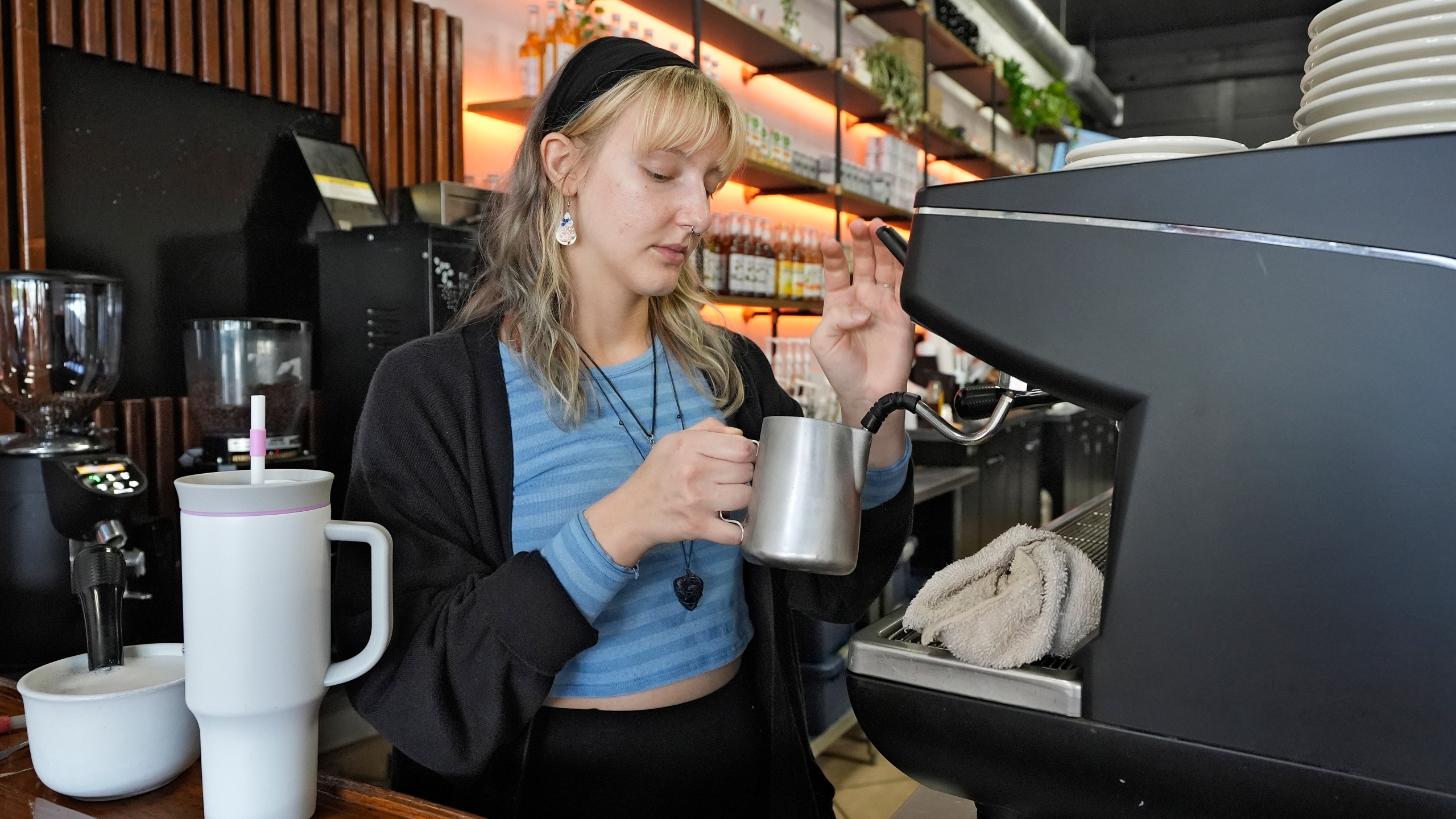 FILE - Samantha Grimison makes a cup of coffee at the Blind Tiger Cafe on Jan. 10, 2024, in Tampa, Fla. On Friday, June 5, 2024, the U.S. government issues its June jobs report. (AP Photo/Chris O'Meara, File)