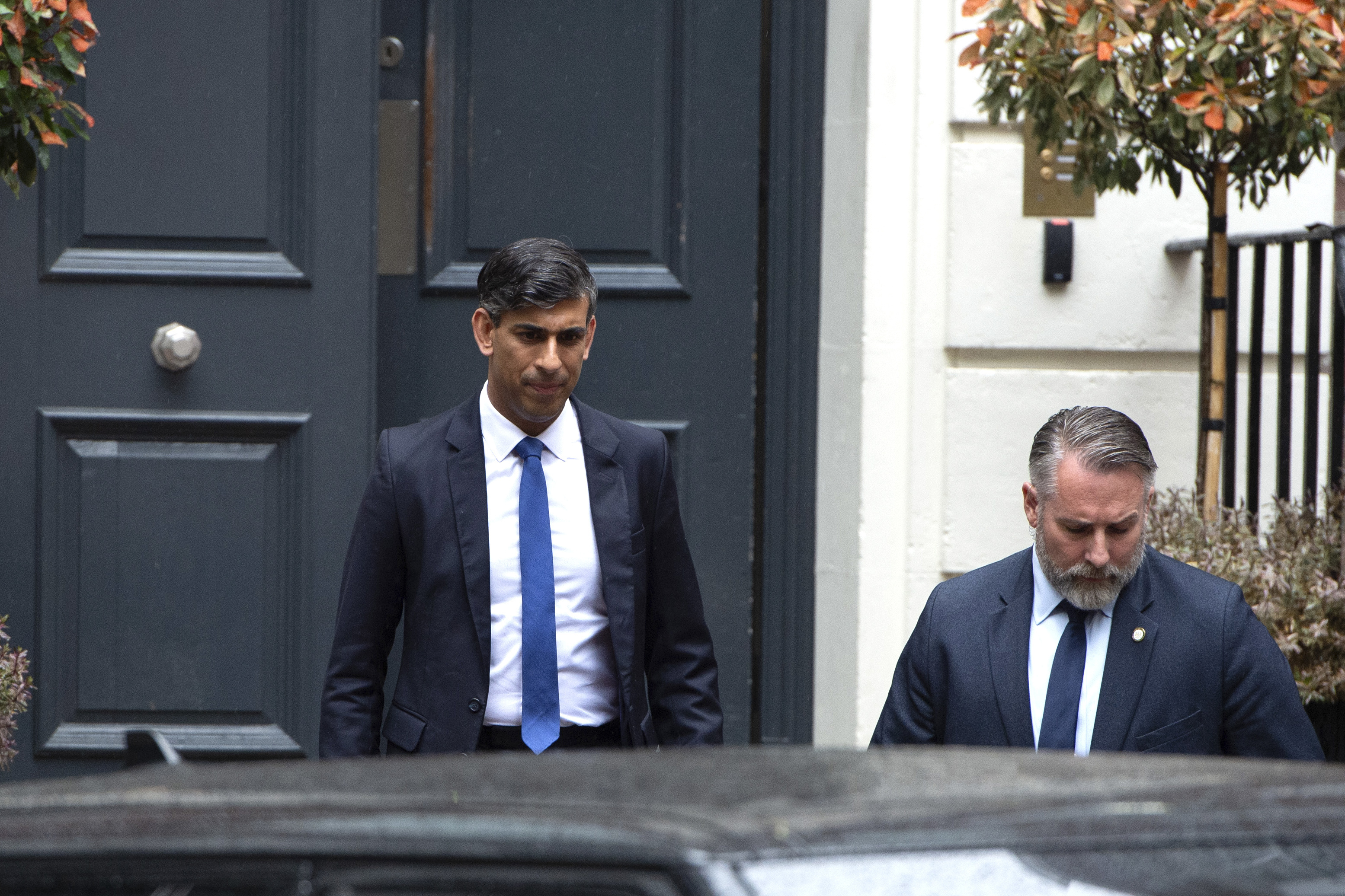 Outgoing British Prime Minister Rishi Sunak, left, leaves the Conservative Campaign Headquarters in London, Friday, July 5, 2024. Britain's Labour Party swept to power Friday after more than a decade in opposition, as a jaded electorate handed the party a landslide victory, but also a mammoth task of reinvigorating a stagnant economy and dispirited nation. (AP Photo/Thomas Krych)