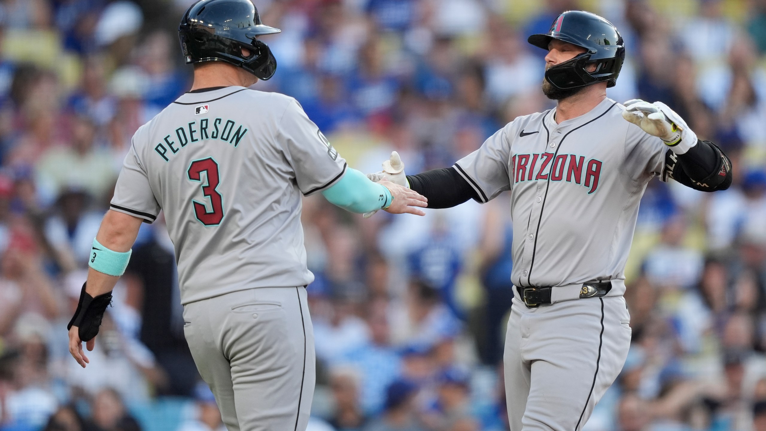 Arizona Diamondbacks' Christian Walker, right, celebrates after his two-run home run with designated hitter Joc Pederson, left, who also scored, during the third inning of a baseball game against the Los Angeles Dodgers, Thursday, July 4, 2024, in Los Angeles. (AP Photo/Ryan Sun)