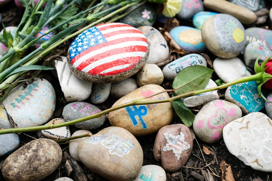 The temporary memorial for the Highland Park shooting victims, Katie Goldstein, Irina McCarthy, Kevin Michael McCarthy, Stephen Straus, Jacki Lovi Sundheim, Nicolás Toledo and Eduardo Uvaldo, is seen near 1707 St. Johns Avenue in Highland Park, Ill., Thursday, July 4, 2024, two years after a mass shooting at the parade. (Pat Nabong/Chicago Sun-Times via AP)