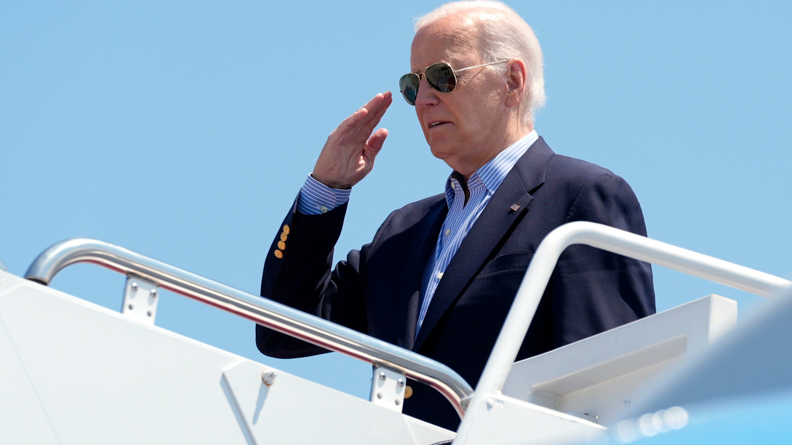 President Joe Biden salutes as he boards Air Force One at Andrews Air Force Base, Md., en route to a campaign trip in Madison, Wis., Friday, July 5, 2024. (AP Photo/Manuel Balce Ceneta)