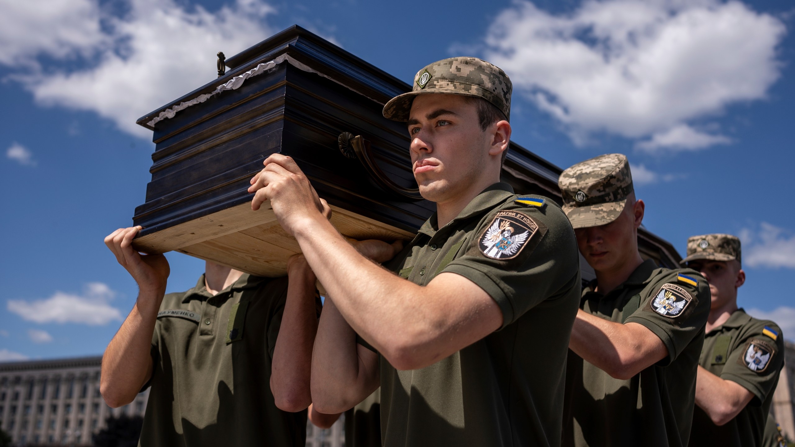 Ukrainian servicemen carry a coffin of British combat medic, volunteer, Peter Fouche, 49 who was killed on June 27 during his work in East Ukraine, at the funeral ceremony on the city's main square in Kyiv, Ukraine, Saturday, July 6, 2024. Peter was founder of a charity organization, which provides vehicles, drones and other needs to Ukrainian servicemen. (AP Photo/Alex Babenko)