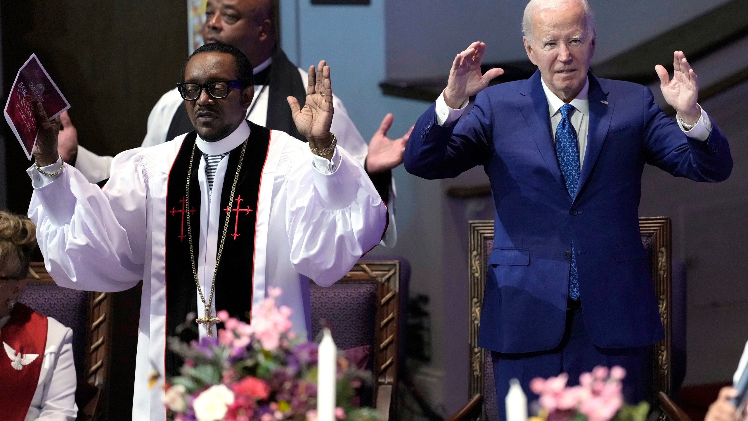 President Joe Biden, right, and pastor Dr. J. Louis Felton pray at a church service at Mt. Airy Church of God in Christ, Sunday, July 7, 2024, in Philadelphia. (AP Photo/Manuel Balce Ceneta)