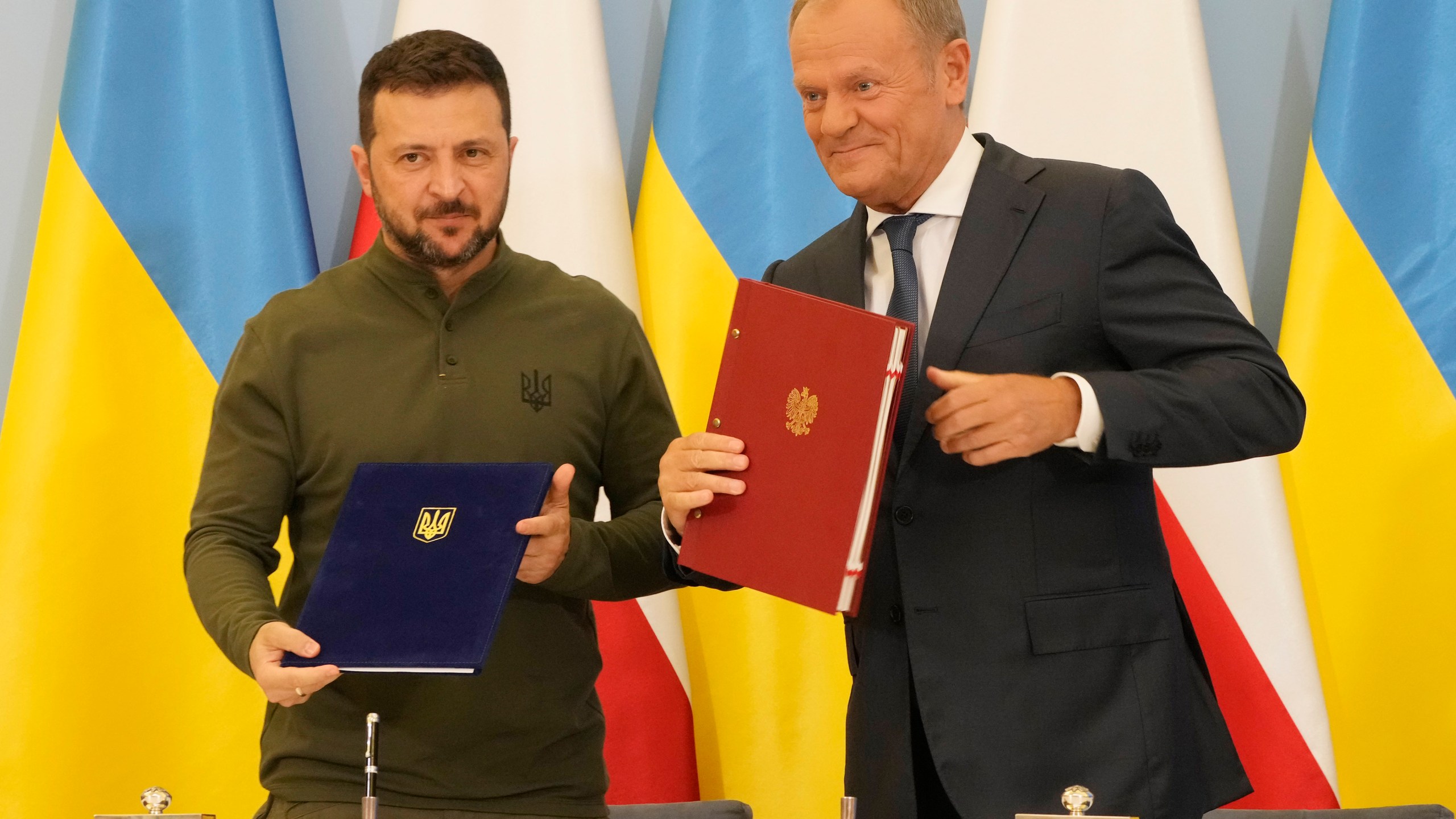 Poland's Prime Minister Donald Tusk, right, and Ukraine's President Volodymyr Zelenskyy after signing an agreement of cooperation and defense, in Warsaw, Poland, on Monday, July 8, 2024. (AP Photo/Czarek Sokolowski)