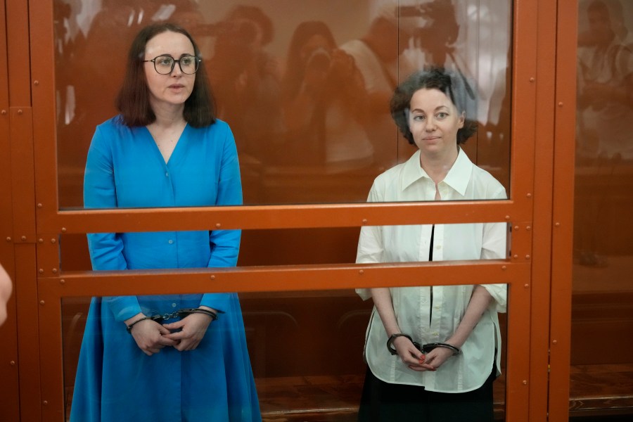 Theater director Zhenya Berkovich, right, and playwright Svetlana Petriychuk are seen in a glass cage prior to a hearing in a court in Moscow, Russia, Monday, July 8, 2024. Berkovich, a prominent independent theater director, and Petriychuk, a playwright have been behind bars since early May. Authorities claim a play they staged, "Finist, the Brave Falcon," justifies terrorism, which is a criminal offence in Russia punishable by up to seven years in prison. (AP Photo/Alexander Zemlianichenko)