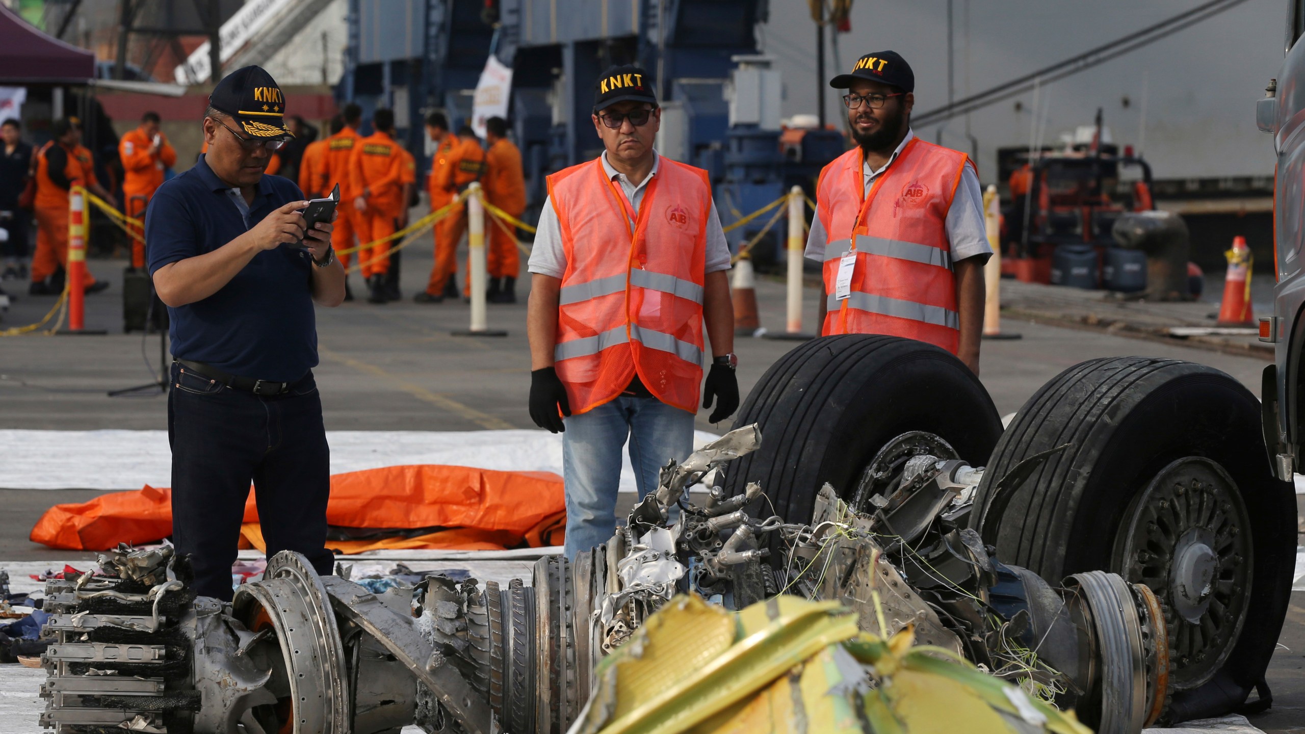 FILE - Officials inspect an engine recovered from the crashed Lion Air jet in Jakarta, Indonesia, Nov. 4, 2018. The brand new Boeing 737 MAX 8 jet plunged into the Java Sea just minutes after takeoff from Jakarta early on Oct. 29, killing all of its passengers on board. On Sunday, July 7, 2024, the Justice Department said Boeing has agreed to plead guilty to a criminal fraud charge stemming from two deadly crashes of 737 Max jetliners. (AP Photo/Achmad Ibrahim, File)