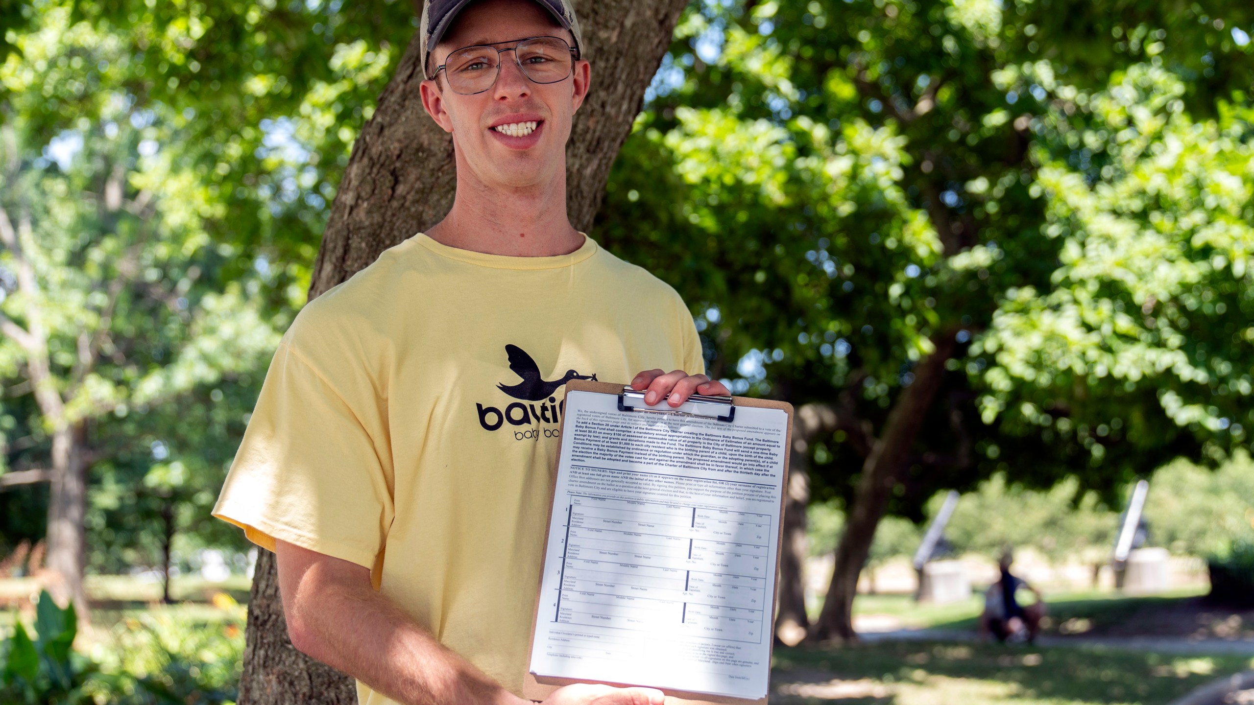 Nate Golden, president of the Maryland Child Alliance, poses for a portrait with a petition form for the Baltimore Baby Fund, Wednesday, July 3, 2024, in Baltimore. (AP Photo/Stephanie Scarbrough)