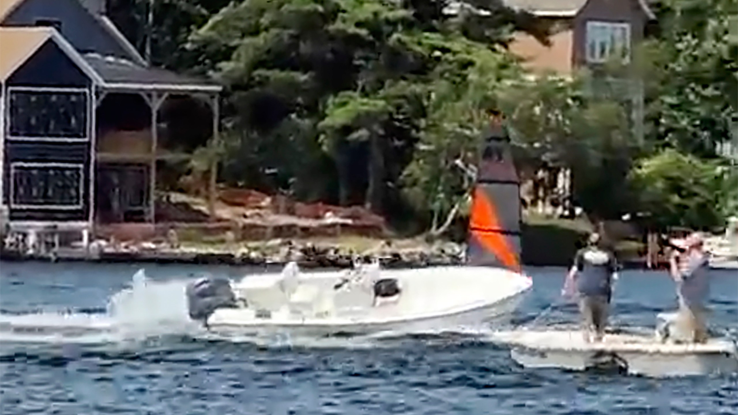 In a still frame from video provided by Rich Bono, an empty runaway boat speeds in circles, Wednesday, July 3, 2024, on Lake Winnipesaukee's Smith Cove, off Gilford, N.H. The empty runaway boat was brought safely to a stop by a teenager who jumped aboard from a personal watercraft. (Rich Bono via AP)