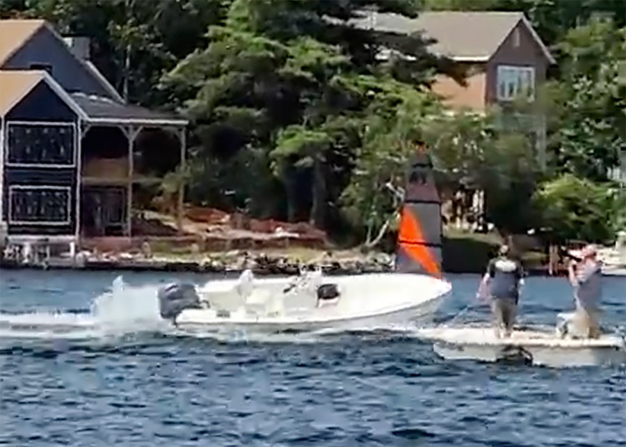 In a still frame from video provided by Rich Bono, an empty runaway boat speeds in circles, Wednesday, July 3, 2024, on Lake Winnipesaukee's Smith Cove, off Gilford, N.H. The empty runaway boat was brought safely to a stop by a teenager who jumped aboard from a personal watercraft. (Rich Bono via AP)