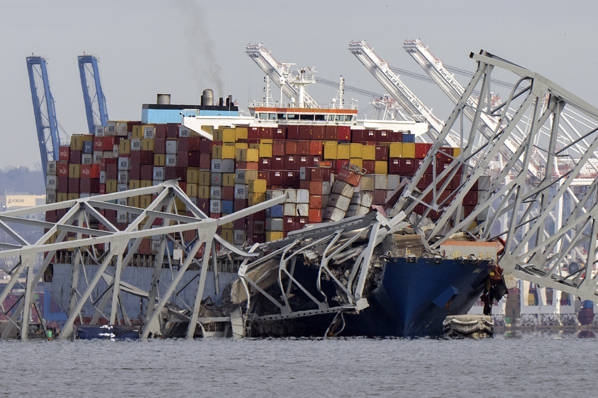 FILE - The cargo ship Dali is stuck under part of the structure of the Francis Scott Key Bridge after the ship hit the bridge, Tuesday, March 26, 2024, as seen from Pasadena, Md. Julio Cervantes Suarez, the only person who survived falling from Maryland's Francis Scott Key Bridge during its catastrophic collapse says he watched in horror as his coworkers, friends and relatives plunged to their deaths. In an exclusive interview with NBC News that aired Wednesday evening, July 10, 2024, he described fighting for his life after his truck tumbled into the Patapsco River. (AP Photo/Mark Schiefelbein, File)