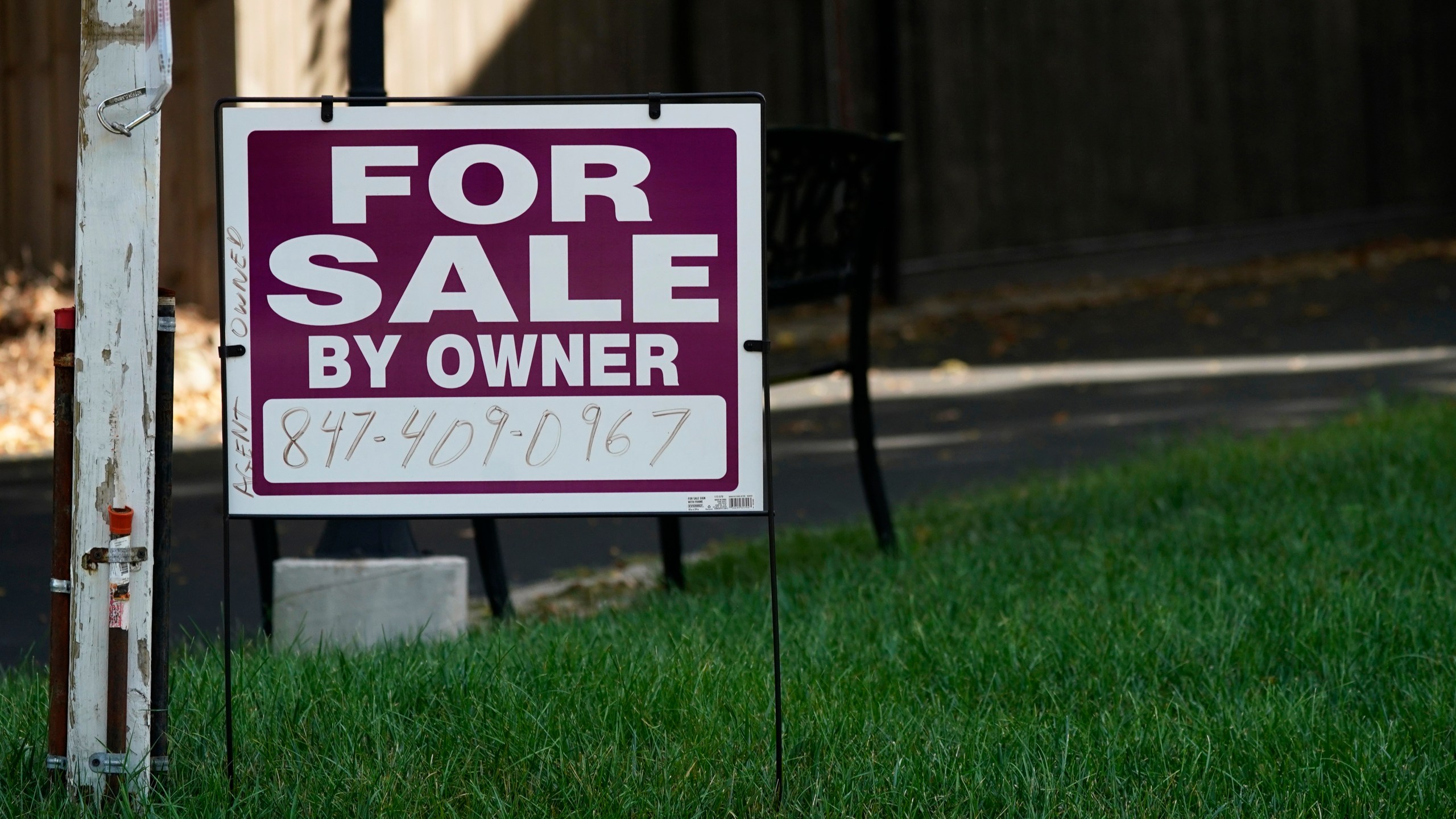 FILE - For sale by owner sign is displayed in Northbrook, Ill., Wednesday, Sept. 21, 2022. Sales of U.S. homes to foreign nationals have fallen to the lowest level in more than a decade, hampered by a strong dollar and many of the affordability hurdles that have kept the housing market in a deep sales slump for over two years. (AP Photo/Nam Y. Huh)