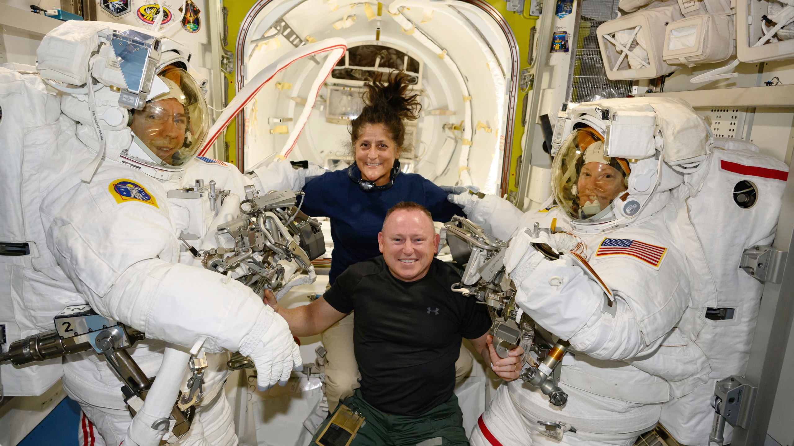 FILE - In this photo provided by NASA, Boeing Crew Flight Test astronauts Suni Williams and Butch Wilmore, center, pose with Expedition 71 Flight Engineers Mike Barratt, left, and Tracy Dyson, aboard the International Space Station's Quest airlock on June 24, 2024. Officials said Thursday, July 18, there’s still no return date for Williams and Wilmore, who have been at the International Space Station since June 6. (NASA via AP, File)