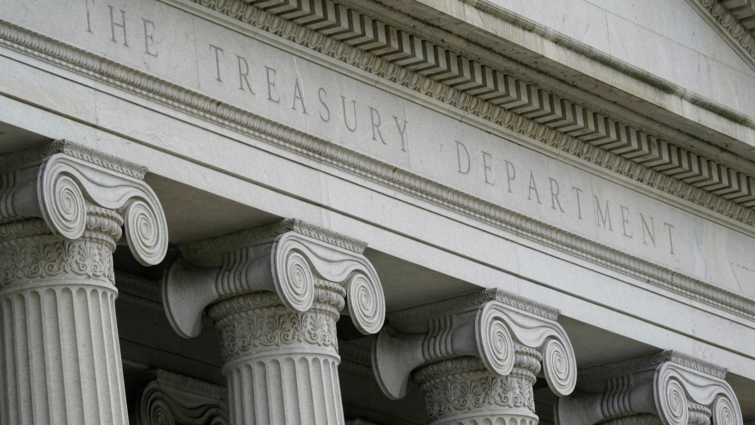 FILE - The Treasury Building is viewed in Washington, May 4, 2021. The Treasury Department is warning that state laws that restrict banks from considering environmental, social and governance factors could harm efforts to address money laundering and terrorism financing. The Associated Press obtained a copy of a letter sent Thursday to lawmakers. The letter single out a law signed by Florida Gov. Ron DeSantis in May that says it would be an “unsafe and unsound practice” for banks to consider non-financial factors when doing business. (AP Photo/Patrick Semansky, File)