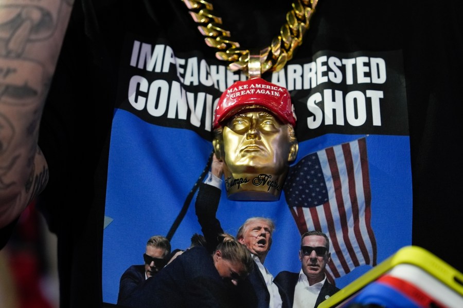 A delegate wears a tee shirt with a photo of Republican presidential candidate former President Donald Trump being surrounded by U.S. Secret Service agents at a campaign rally during the Republican National Convention Monday, July 15, 2024, in Milwaukee. (AP Photo/Julia Nikhinson)