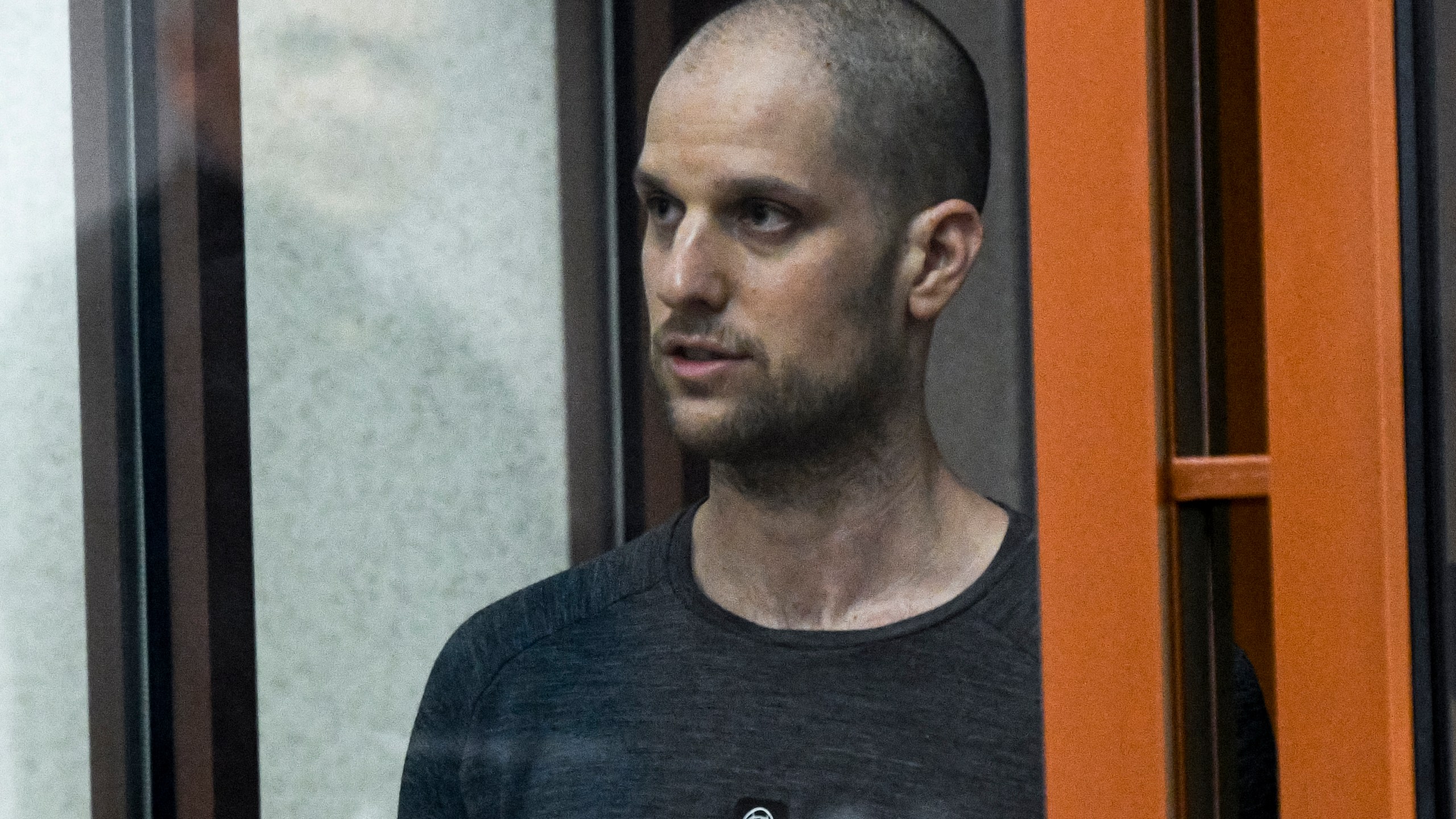 Wall Street Journal reporter Evan Gershkovich stands listening to the verdict in a glass cage of a courtroom inside the building of "Palace of justice," in Yekaterinburg, Russia, on Friday, July 19, 2024. A Russian court convicted Gershkovich on espionage charges that his employer and the U.S. have rejected as fabricated. He was sentenced to 16 years in prison after a secretive and rapid trial in the country's highly politicized legal system. (AP Photo)