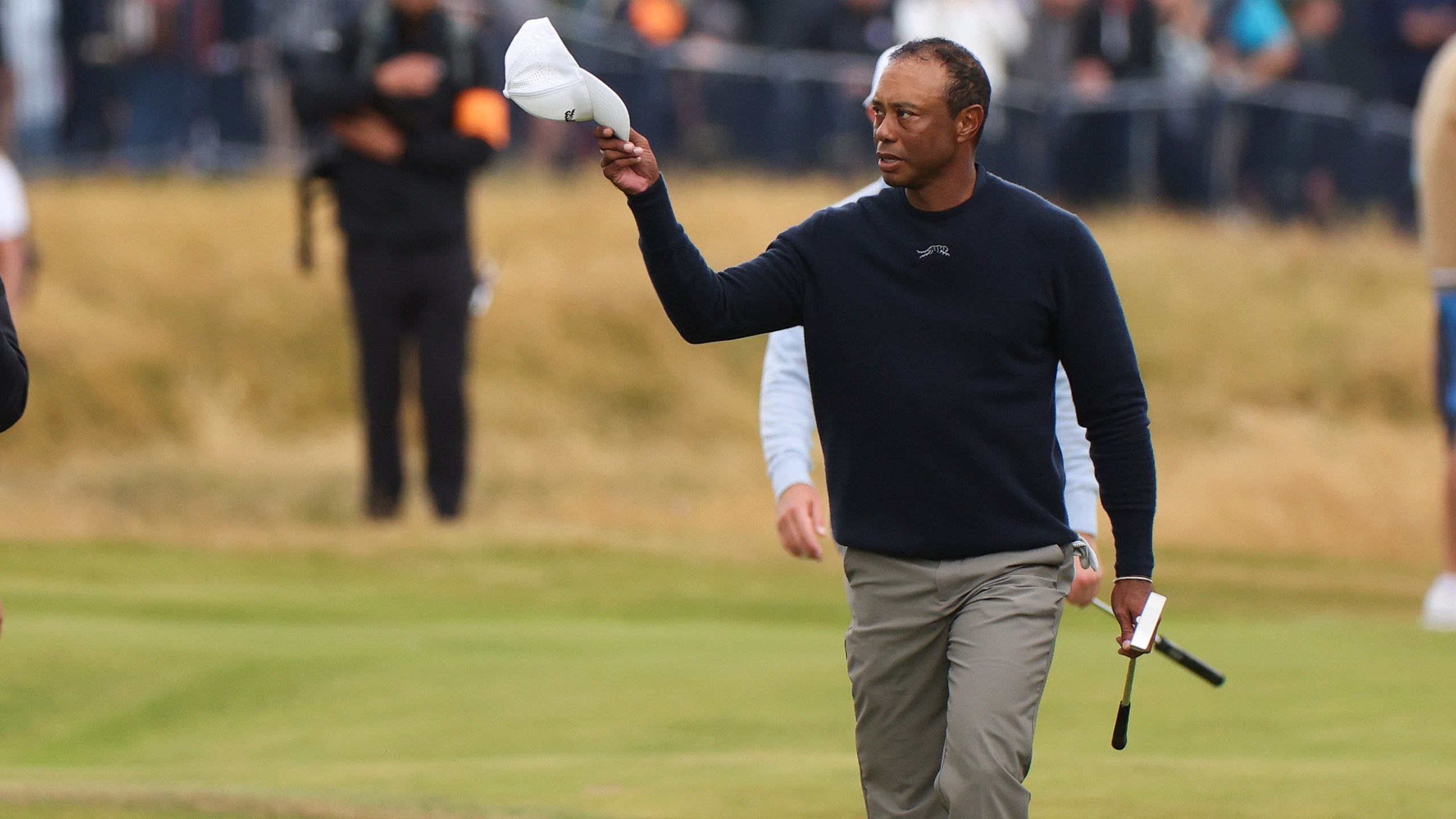 Tiger Woods of the United States waves as he walks to the 18th green during his second round of the British Open Golf Championships at Royal Troon golf club in Troon, Scotland, Friday, July 19, 2024. (AP Photo/Scott Heppell)